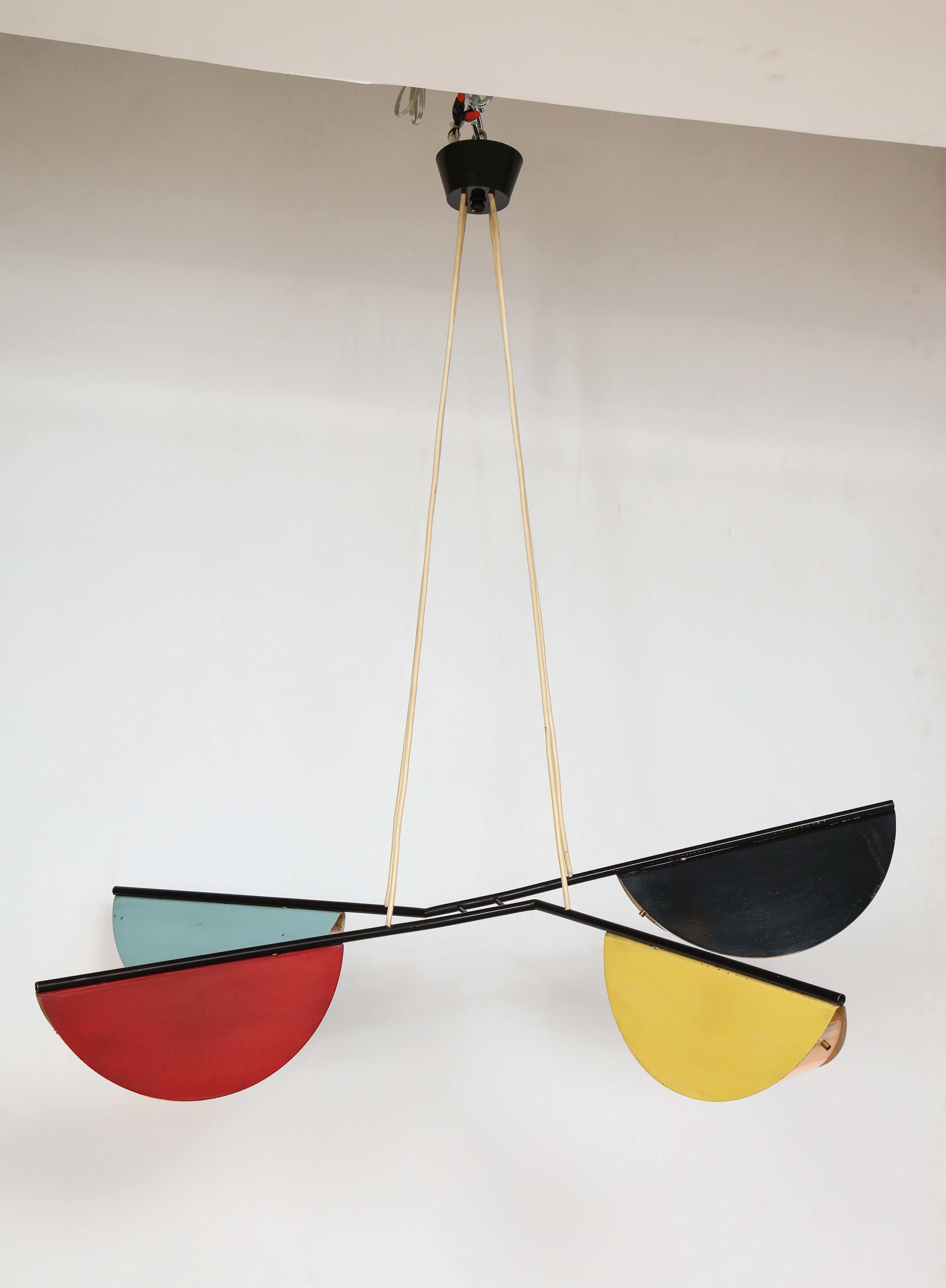 French (possibly Italian) midcentury suspension four arm light (chandelier), France, circa 1950
In the style of Prouvé and Charlotte Perriand's work of the same time period.

Enameled metal demilune shape lamps in light blue, red, black,