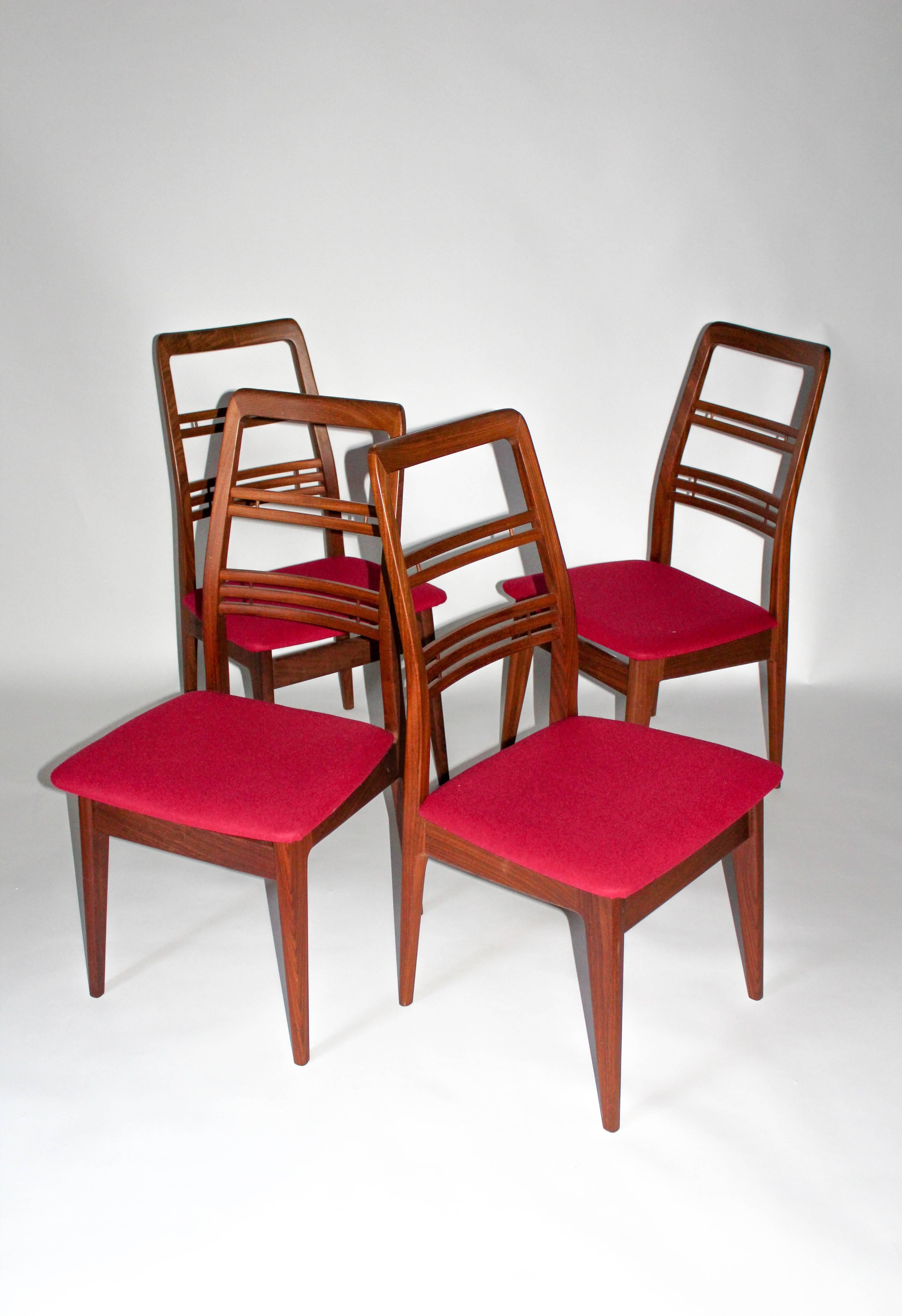 Set of four high back dining chairs by the Swedish designer Svante Skogh. The chairs are made out of teak and are newly upholstered in a cerise 100% wool fabric from Klippan Yllefabrik. Very good vintage condition with minor signs of usage, one