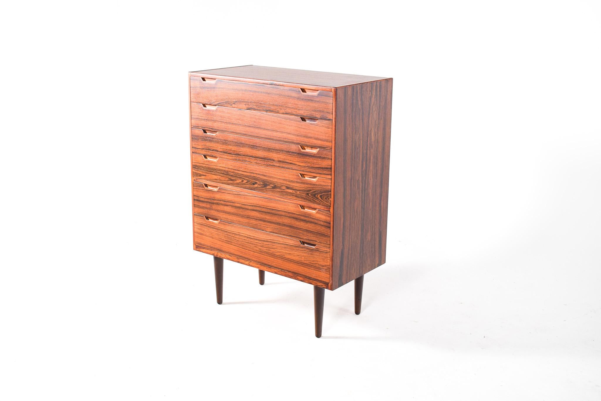 Mid Century rosewood chest of drawers, designed by Svend Langkilde in the 1960´s, Denmark. 
An example of excellent craftsmanship, amazing joinery and design. Detailed handles in massive rosewood. 
Great rosewood veneer, chosen carefully to have a