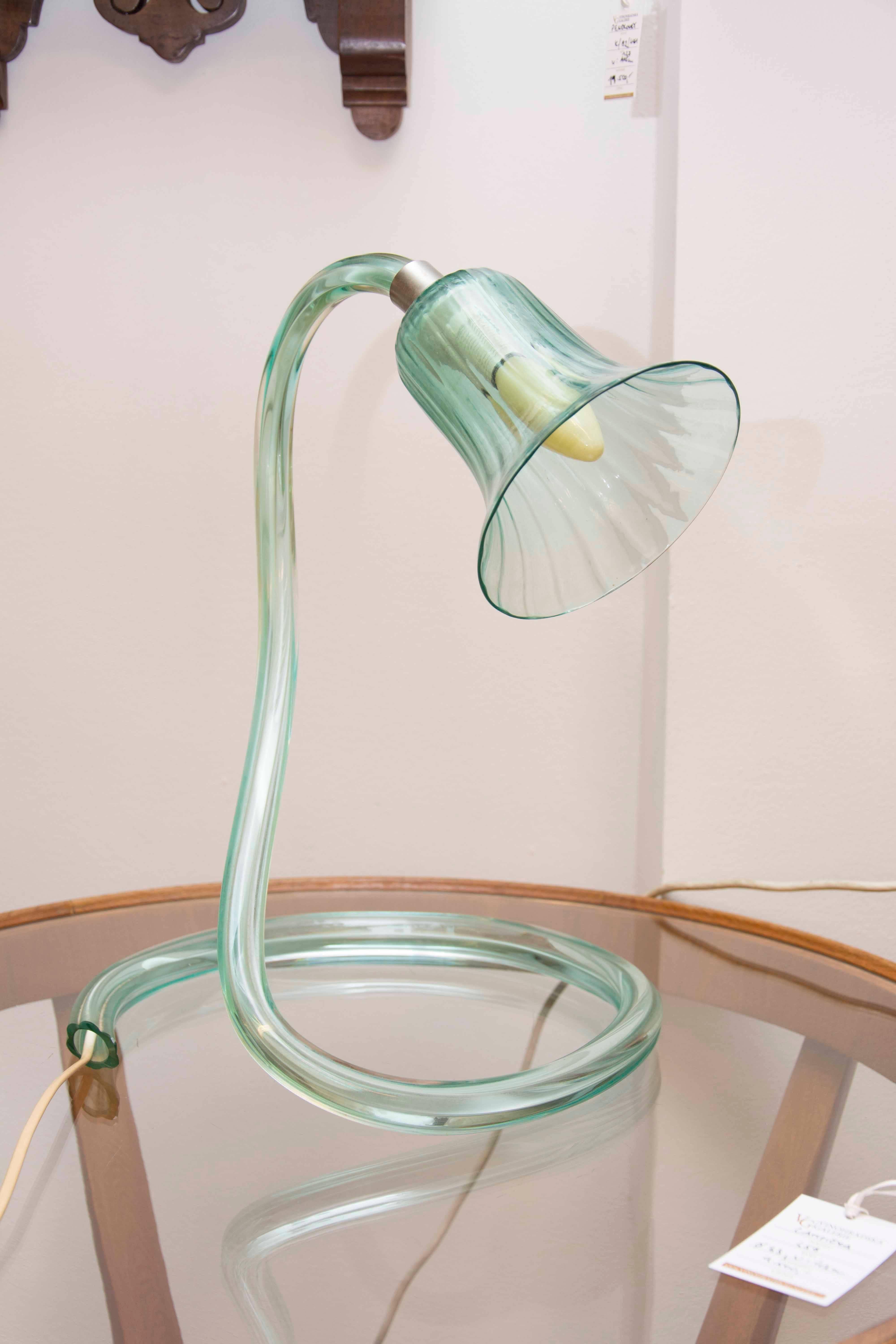 This magnificent light green Murano glass lamp was made in the middle of the last century in Italia. It is sensitive to the shape of a swan. It is in excellent condition with new wiring.