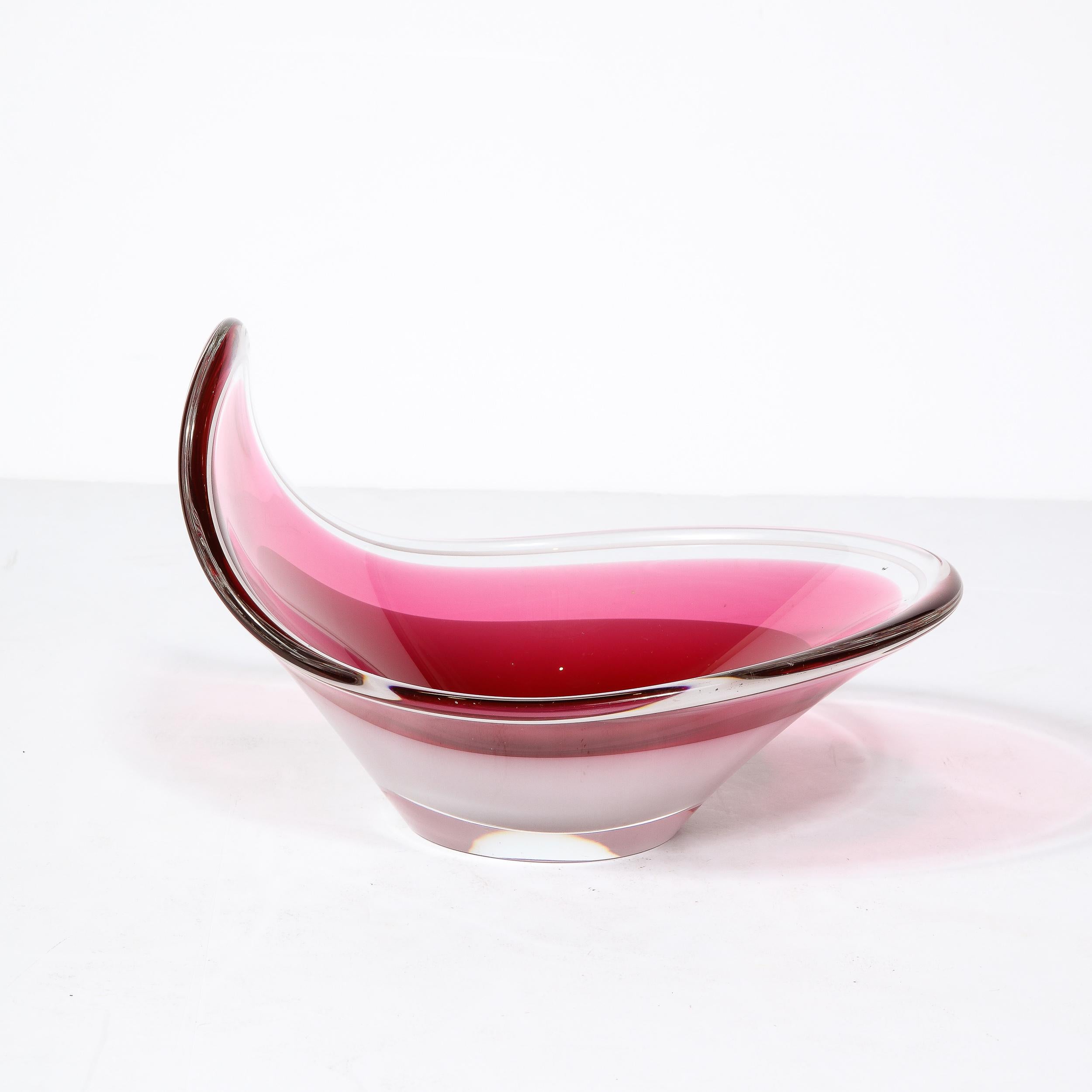 This curvaceous and elegant Ruby Centerpiece originates from Sweden during the 1960 by Flygsfors Coquille. The rounded elliptical edge swells from a flattened base, one side curving upwards and creating a brilliant feeling of depth to the center. In