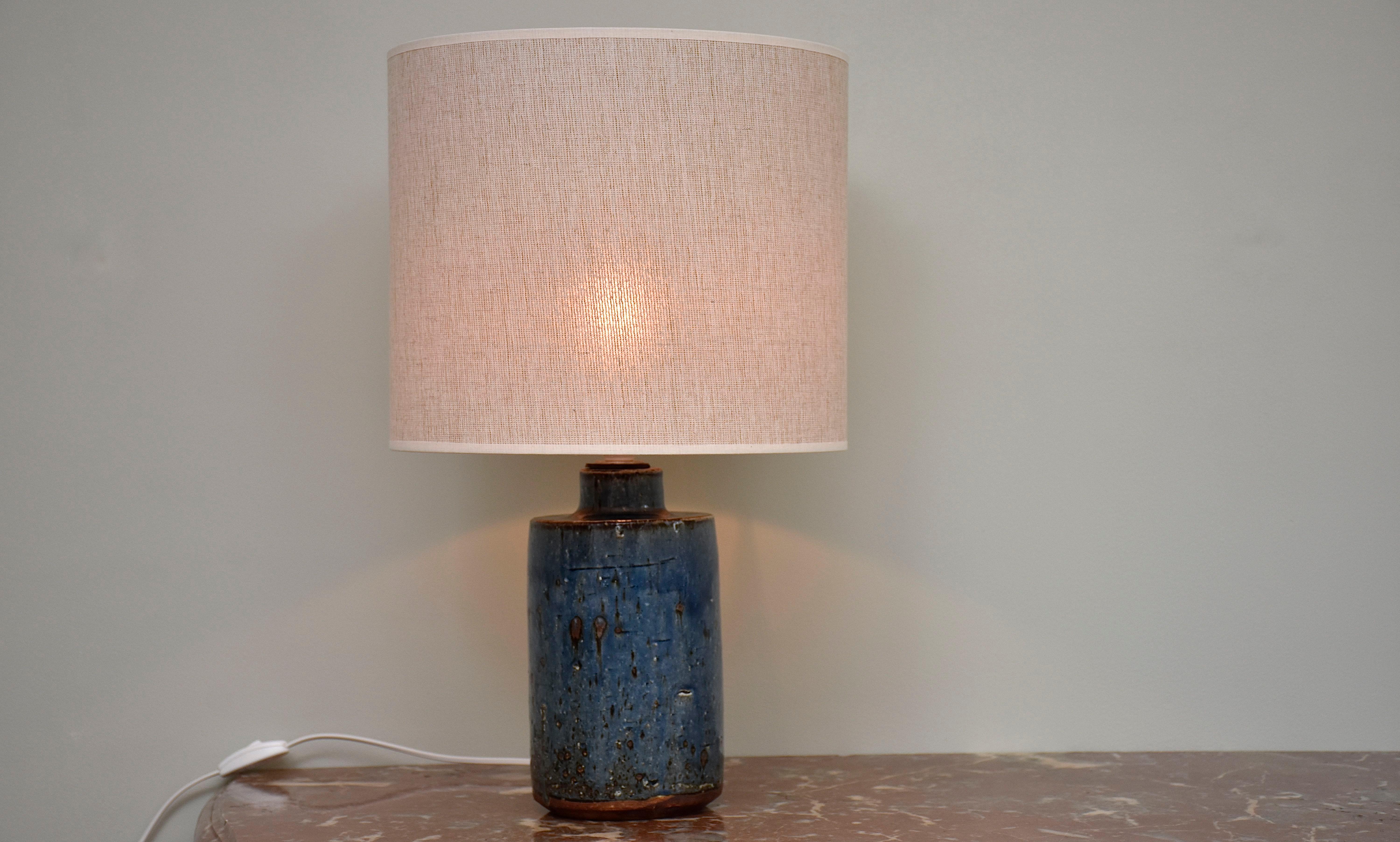 Eine wunderschöne blaue Tischlampe aus Steinzeug, entworfen und handgefertigt von Marianne Westmann, schwedische Designerin und Keramikerin.
Die Lampe wurde für die berühmte Keramikfabrik Rorstrand in Schweden hergestellt.
Mit 1x Licht.
Unten