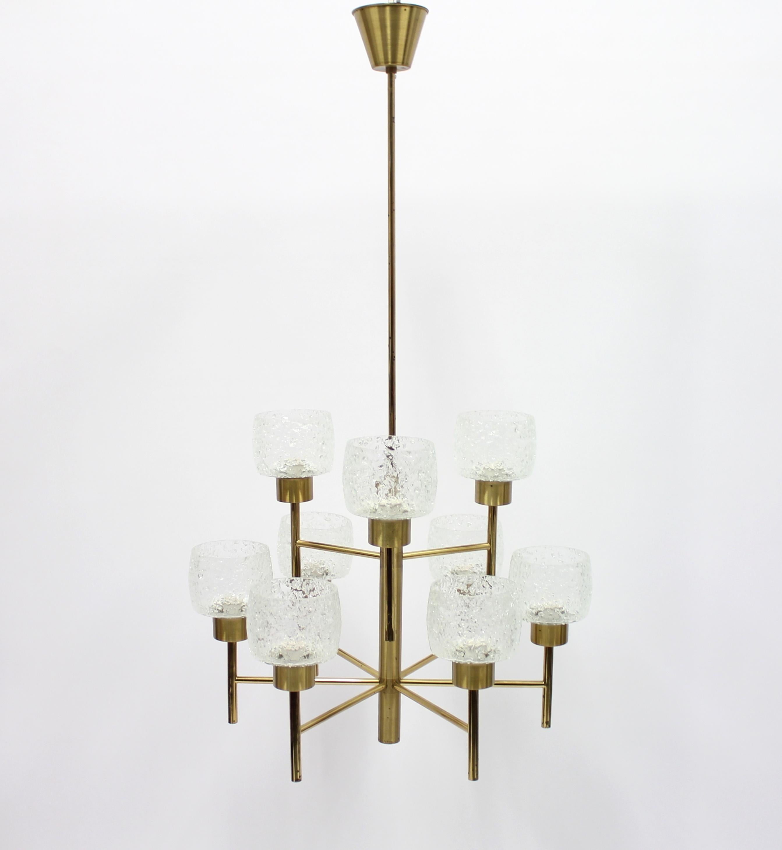 Large 1960s 9-light brass chandelier with glass shades. Most likely a Swedish manufacture. Restored electric components. Good vintage condition.
