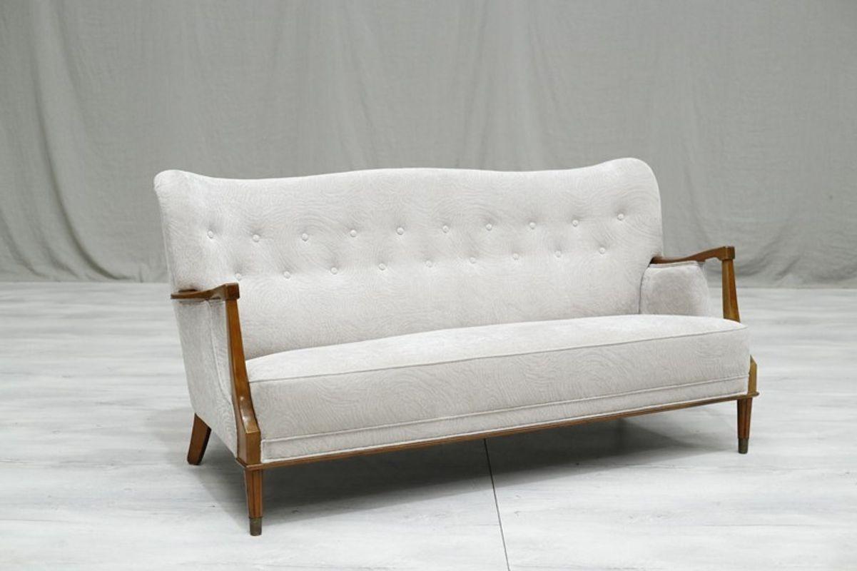This is a very stylish mid century Swedish sofa which I have opted to upholster in a gorgeous quality textured white material. The sofa is a good size sitting upto 3 adults. It has an exposed frame with elegant details and brass capped feet. The