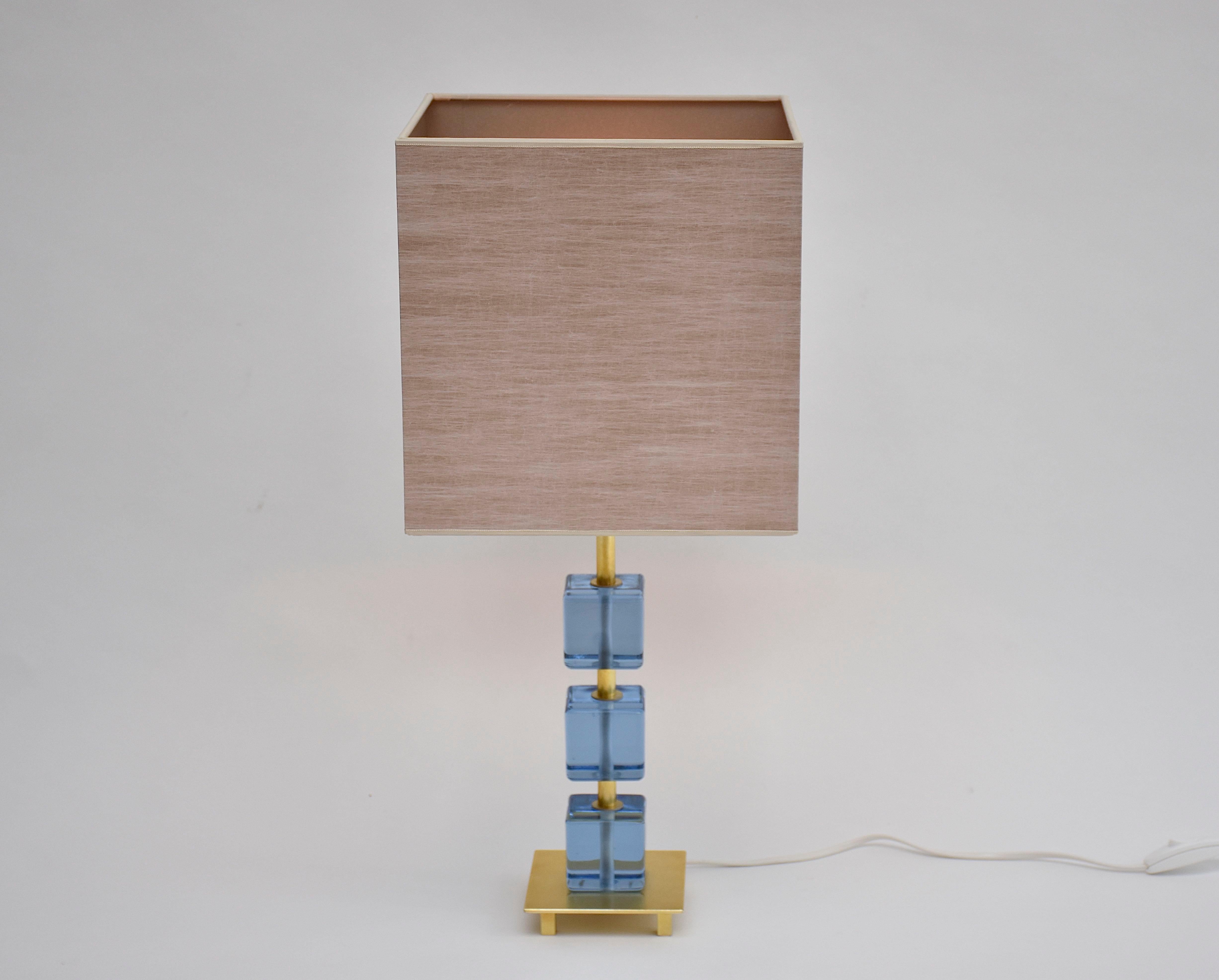 Beautiful Swedish table lamp with 3 soft blue glass blocks.
The lamp was made in Malmö, Sweden in ca. 1960.
Including new high quality hand made lampshade.

Height of the lamp is measured including the shade!
Dimensions shade: 25 cm x25 cm x 25