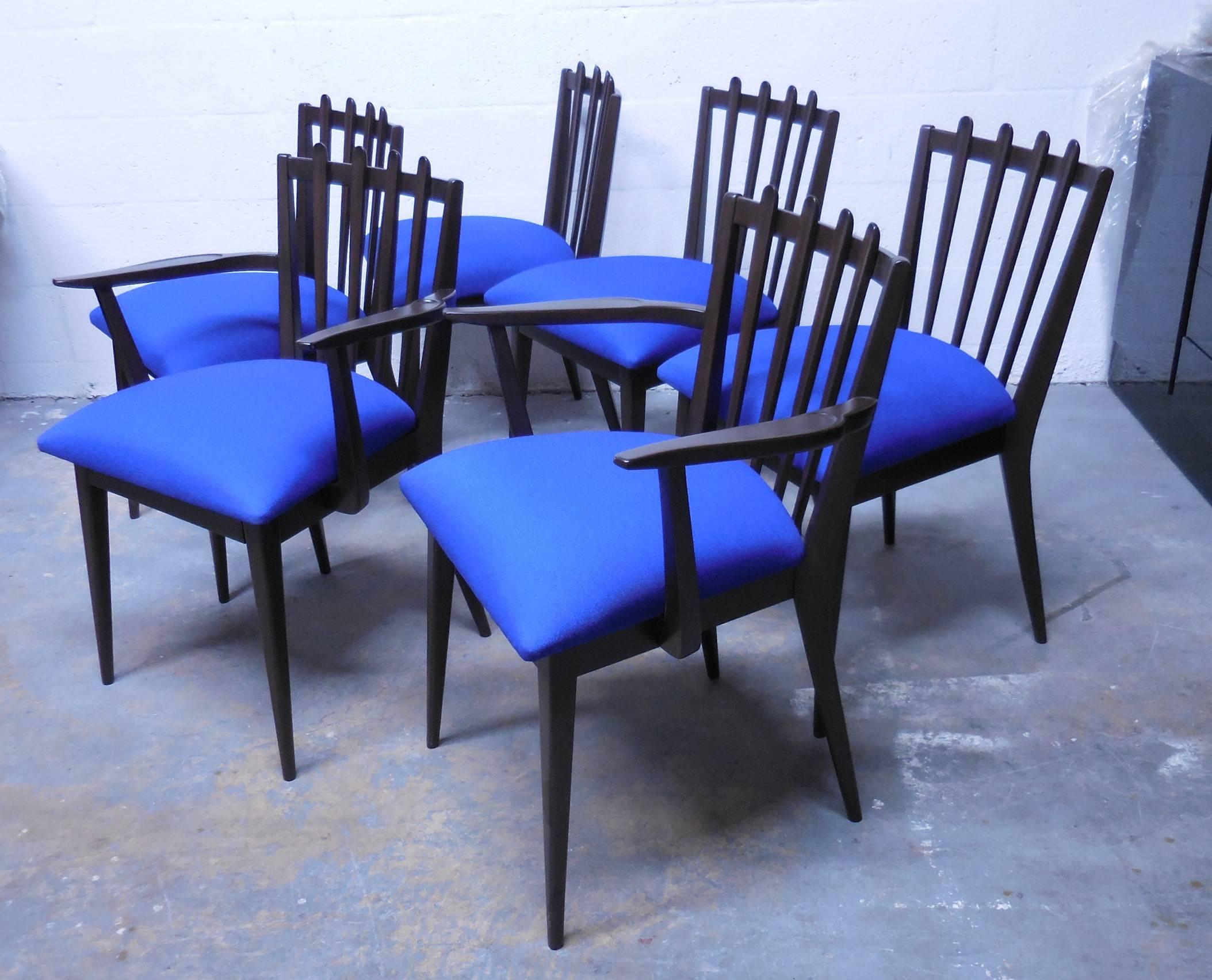 Set of six midcentury dining chairs. Wood frames with upholstered seats. The arms and slats on the backs are subtly carved. Side chairs are 32