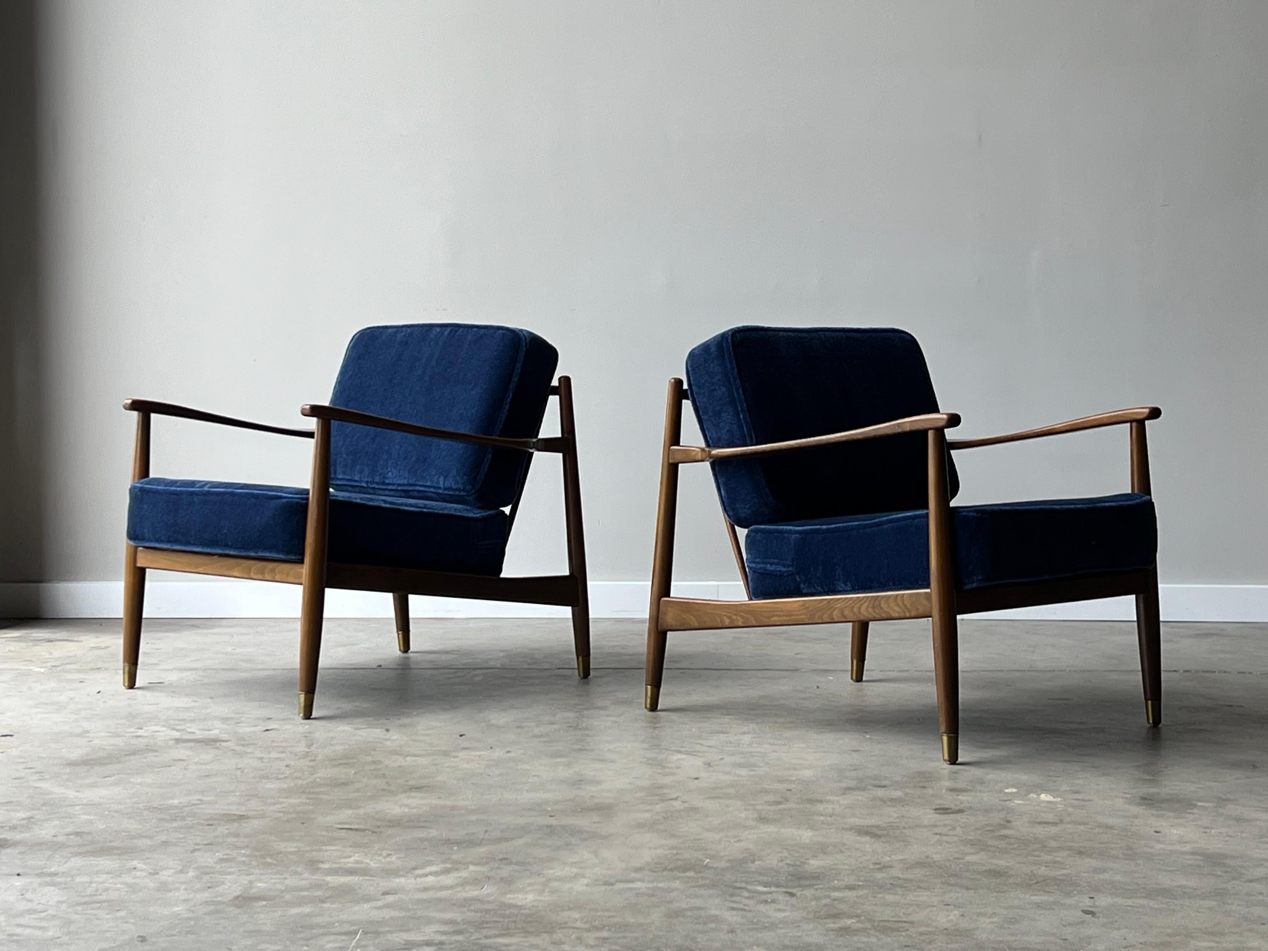 Designed by Folke Ohlsson for Dux and made in Sweden circa 1960s. New foam and beautiful blue Mohair fabric. Thick, soft, and extremely comfy. Sleek and low profile pair of Dux lounges with spindle backs and brass feet. A wonderful pair for many