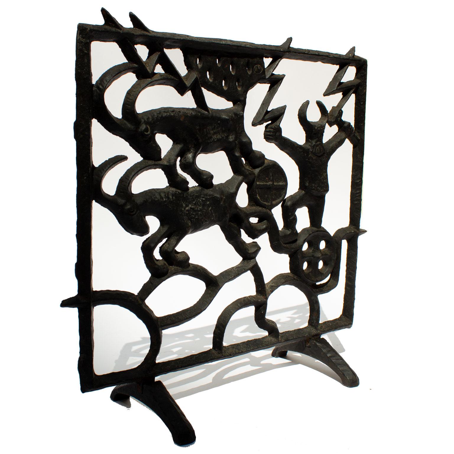 Midcentury Swedish fireplace screen by Olle Hermansson for Husqvarna. A cast iron fireplace with a theme from the nordic mythology. We can see Thor (Tor) and his running goats and the hammer Mjöllnir. Thor was the god of the storm, and thunder. The