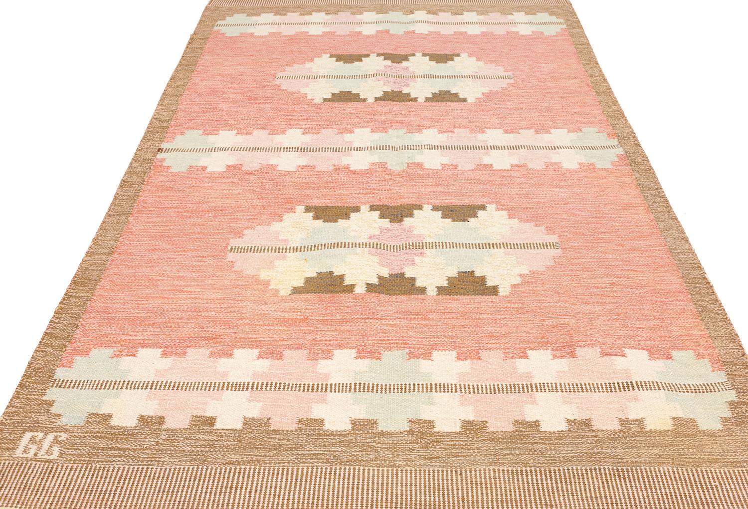 This is a semi-antique Swedish kilim woven circa 1950 and it measures 235 X 162 cm. It bares initial of GG (Gitt Grannsjo Carlsson) with a beautiful soft pastel color palette and geometric cross motifs design. An elegant and attractive piece.