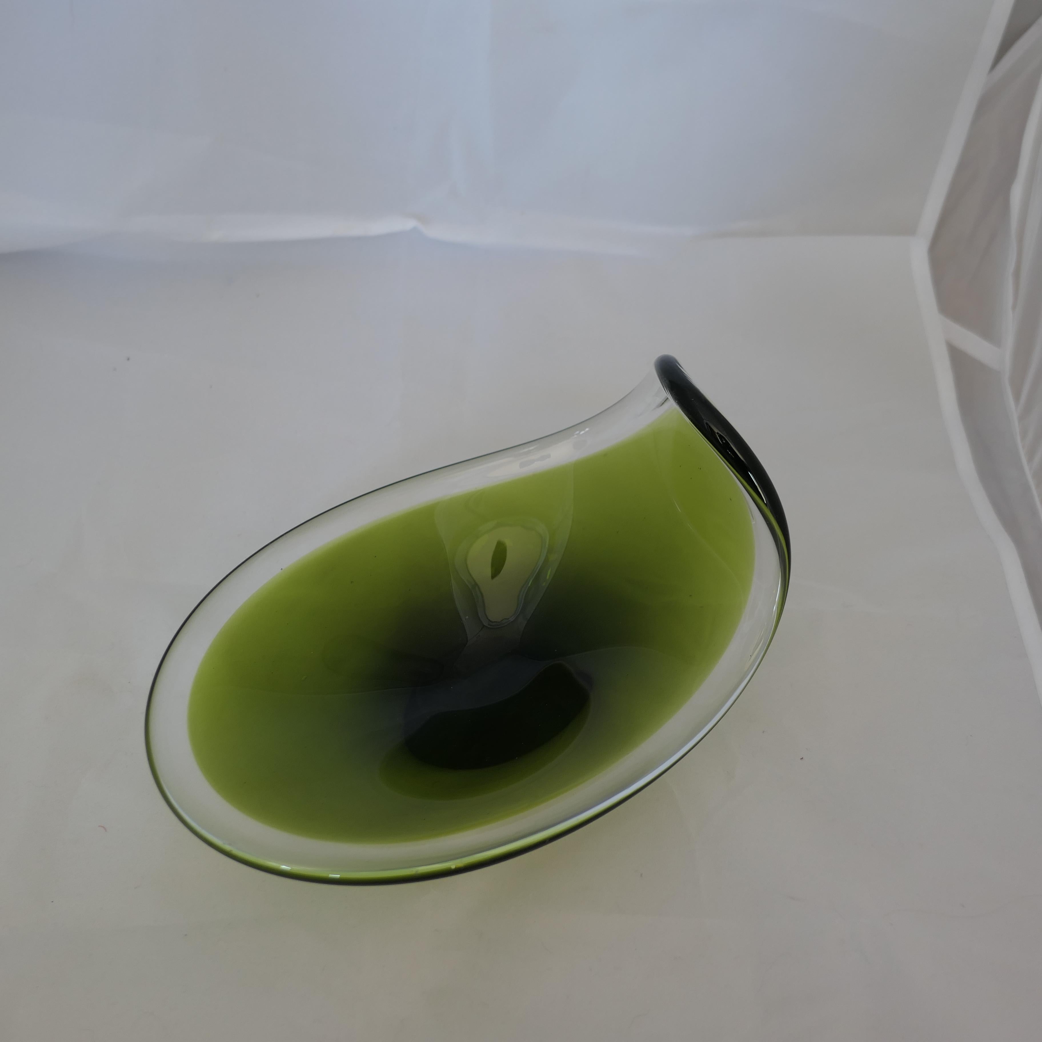 Mid Century Swedish Flygsfors Art Glass Bowl by Paul Kedelv.

Here we have a classic retro Swedish olive green art glass bowl
A superb and Stylish classic it is 6” tall, 9” long and 6.5” wide 
FB216
