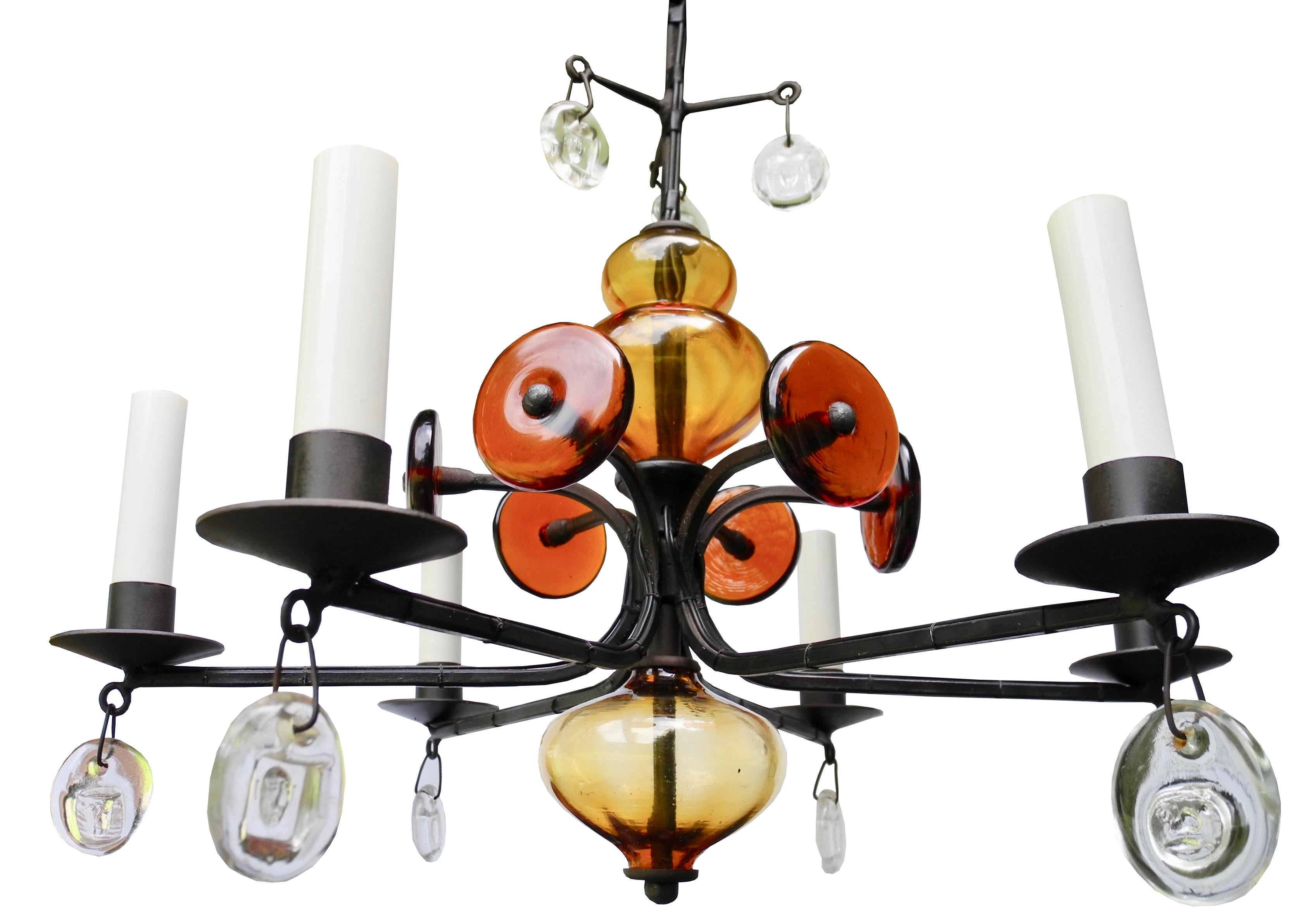 This original Kosta Boda chandelier was designed by Eric Hoglund. This candelabrum is factory electrified for light bulbs. Made of hand forged wrought iron and hand blown glass. The hanging drop glass is clear and the interior glass is dark and