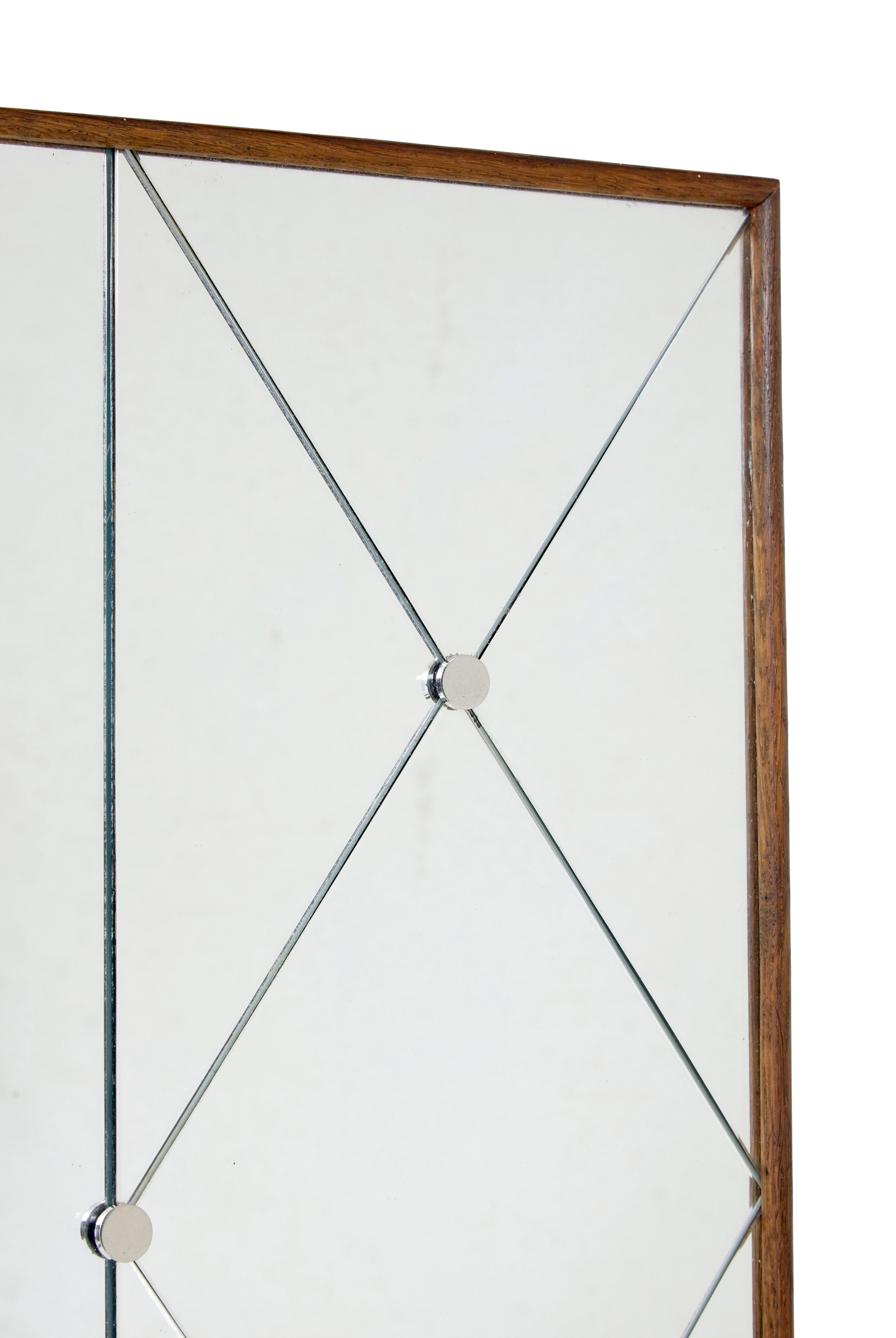 Mid century Swedish harlequin mirror in oak frame circa 1950.

Know as harlequin mirrors because of the segmented triangular cut borders, this mirror very much likely to have been made by g&t.

Triangular segmented border around a main rectangular