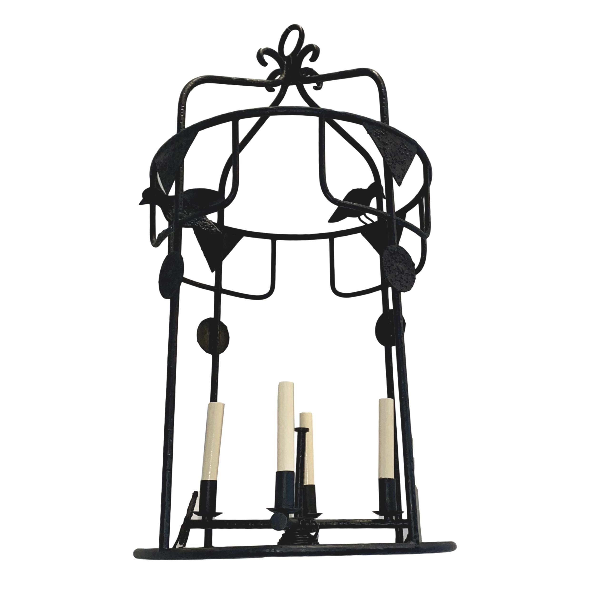 A circa 1960s Swedish hammered wrought iron open-panel lantern with figures of birds and a four-light central cluster of candelabra lights.
Measurements:
Minimum drop: 36