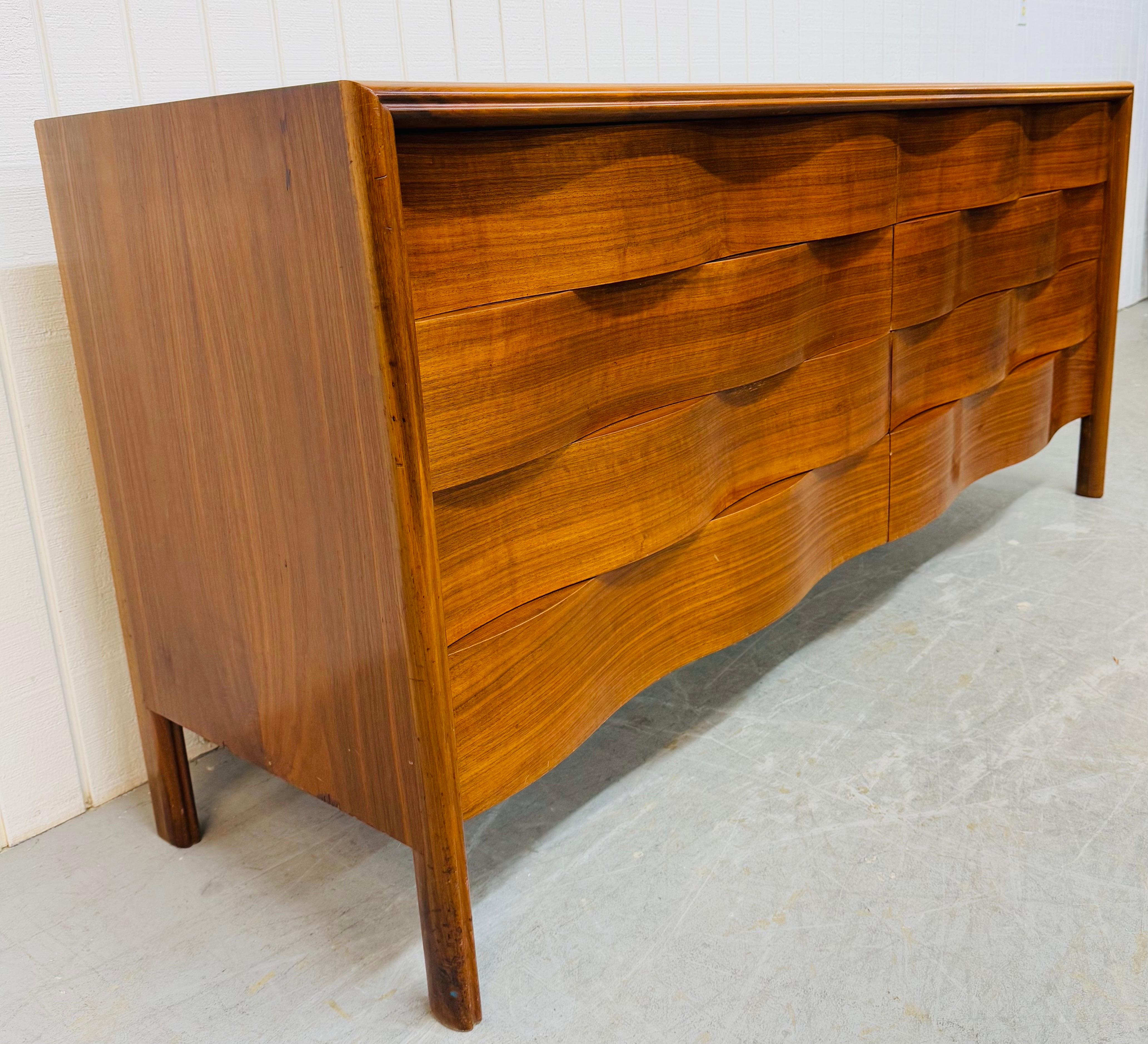 This listing is for a Mid-Century Swedish Modern Edmond Spence Wave Walnut 4-Piece Bedroom Set. Featuring a straight line wave front design, rolling tambour door high chest, eight drawer dresser, two drawer nightstands, modern legs, and beautiful