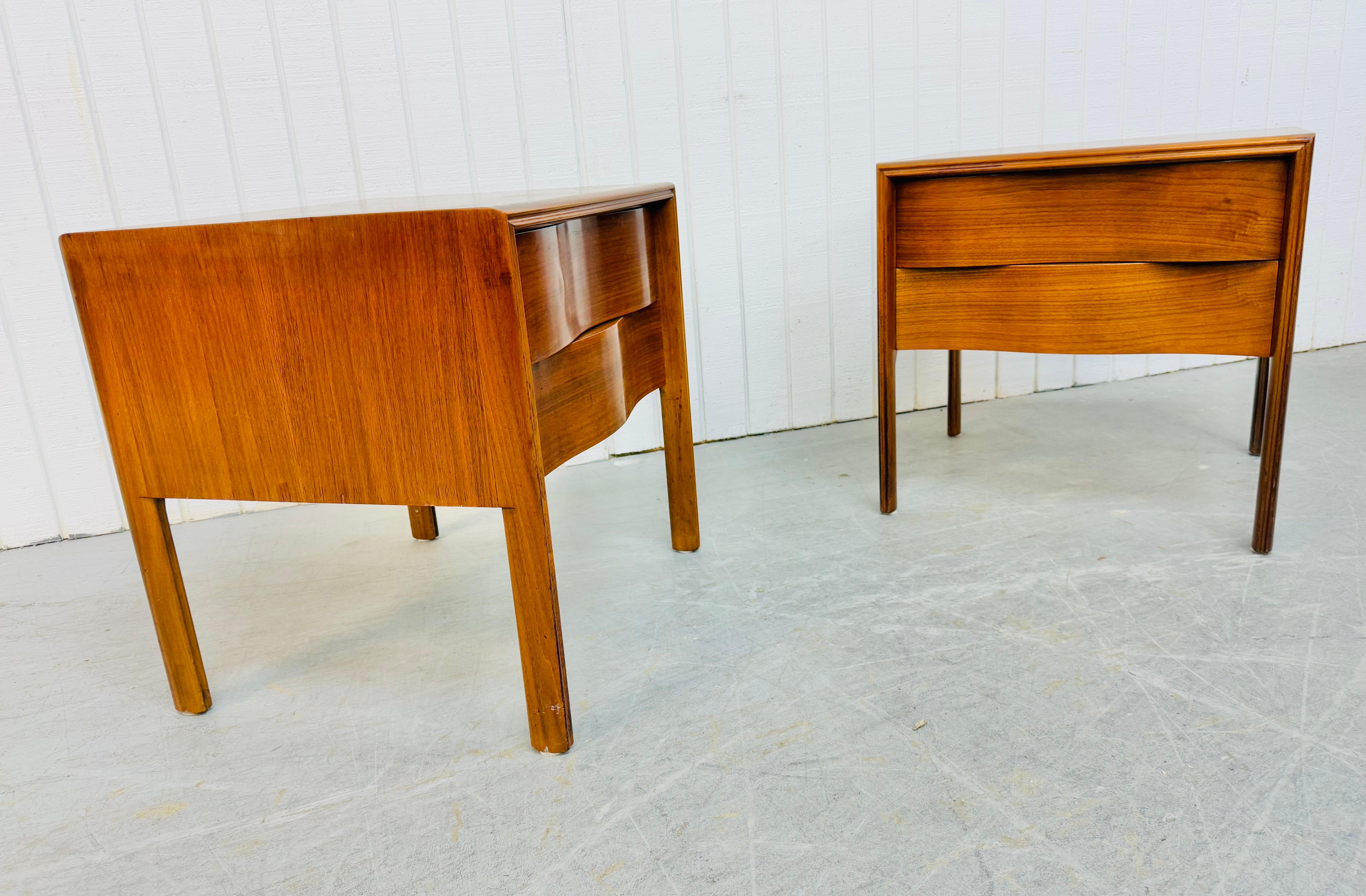 This listing is for a pair of Mid-Century Swedish Modern Edmond Spence Wave Walnut Nightstands. Featuring a straight line wave front design, two drawers for storage, long modern legs, and a beautiful walnut finish. This is an exceptional combination