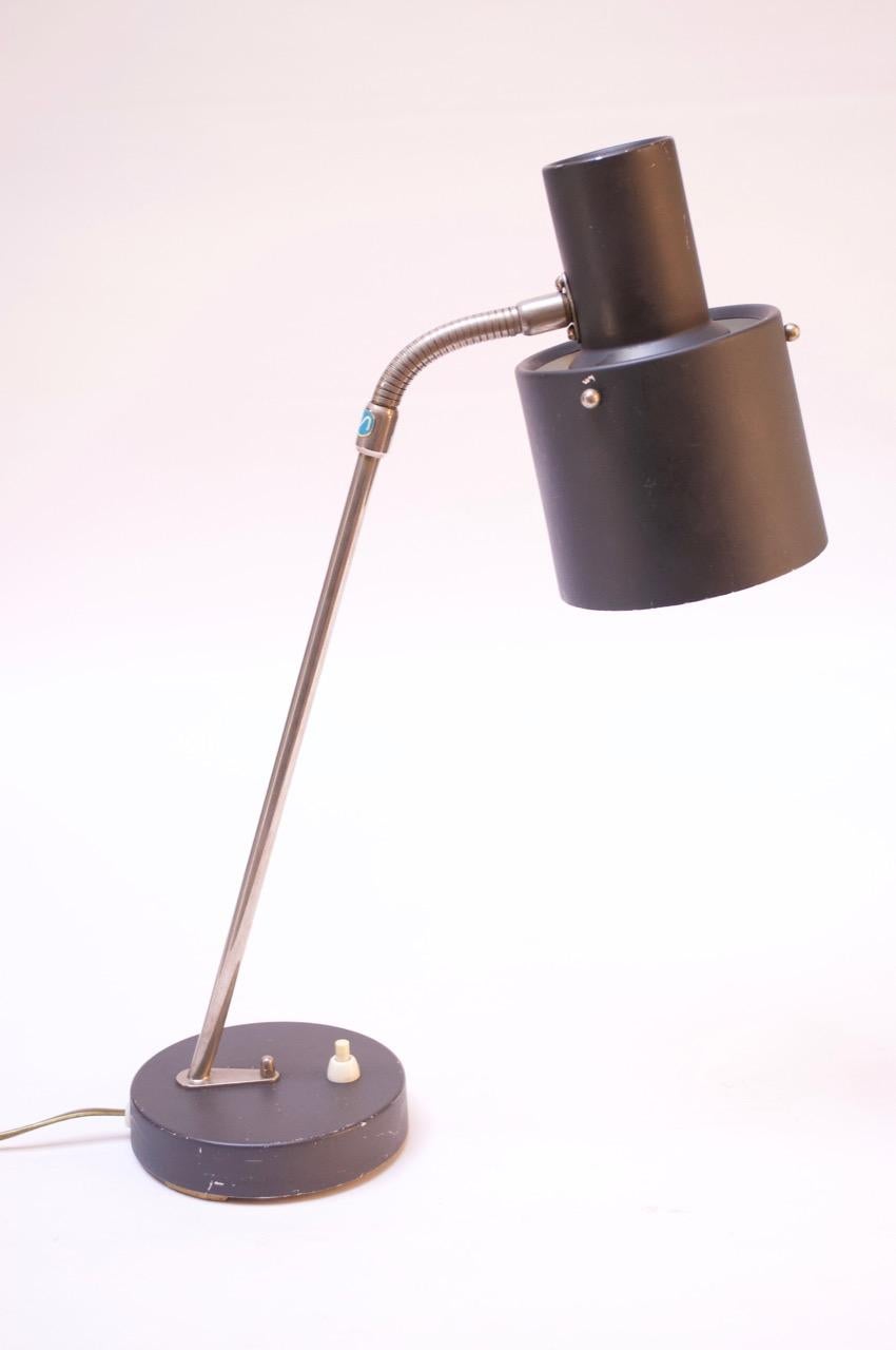 Gooseneck table lamp manufactured by Ewå Belysning of Värnamo of Sweden circa 1950s. Composed of a slate gray lacquered metal shade and base with chromed-metal accents and stem. Shade can be adjusted slightly upward / downward, and gooseneck