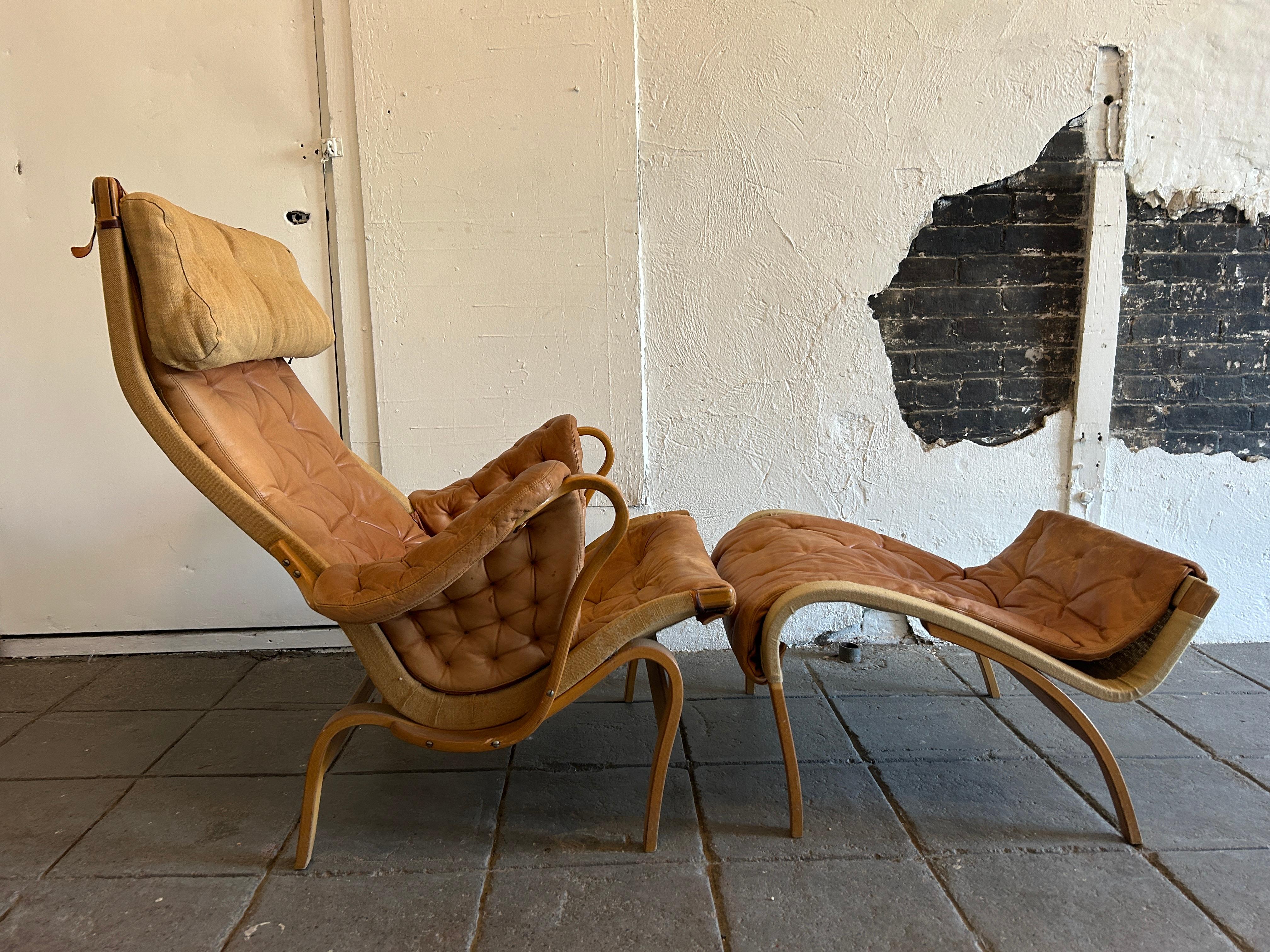 Fabulous Swedish modern all original lounge chair with Ottoman designed by Bruno Mathsson. The bentwood Pernilla chair was made in the 1960 for DUX. Original soft beige colored leather in good vintage condition shows wear patina and fading. DUX