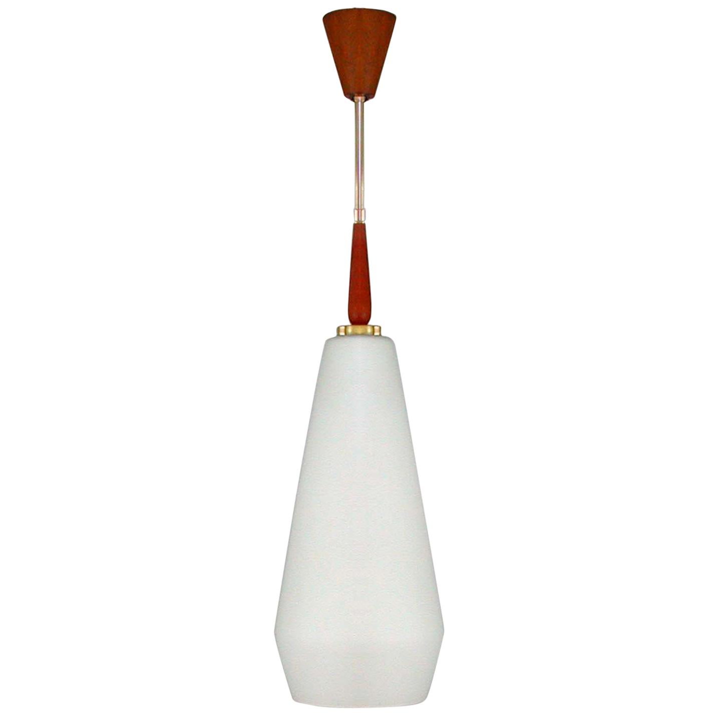 This large Mid-Century Modern pendant was designed and manufactured in Sweden in the 1960s and is attributed to Luxus Vittsjö. Very elegant style influenced by the upcoming Space Age. 

It has got a very large frosted opaline glass lamp shade with