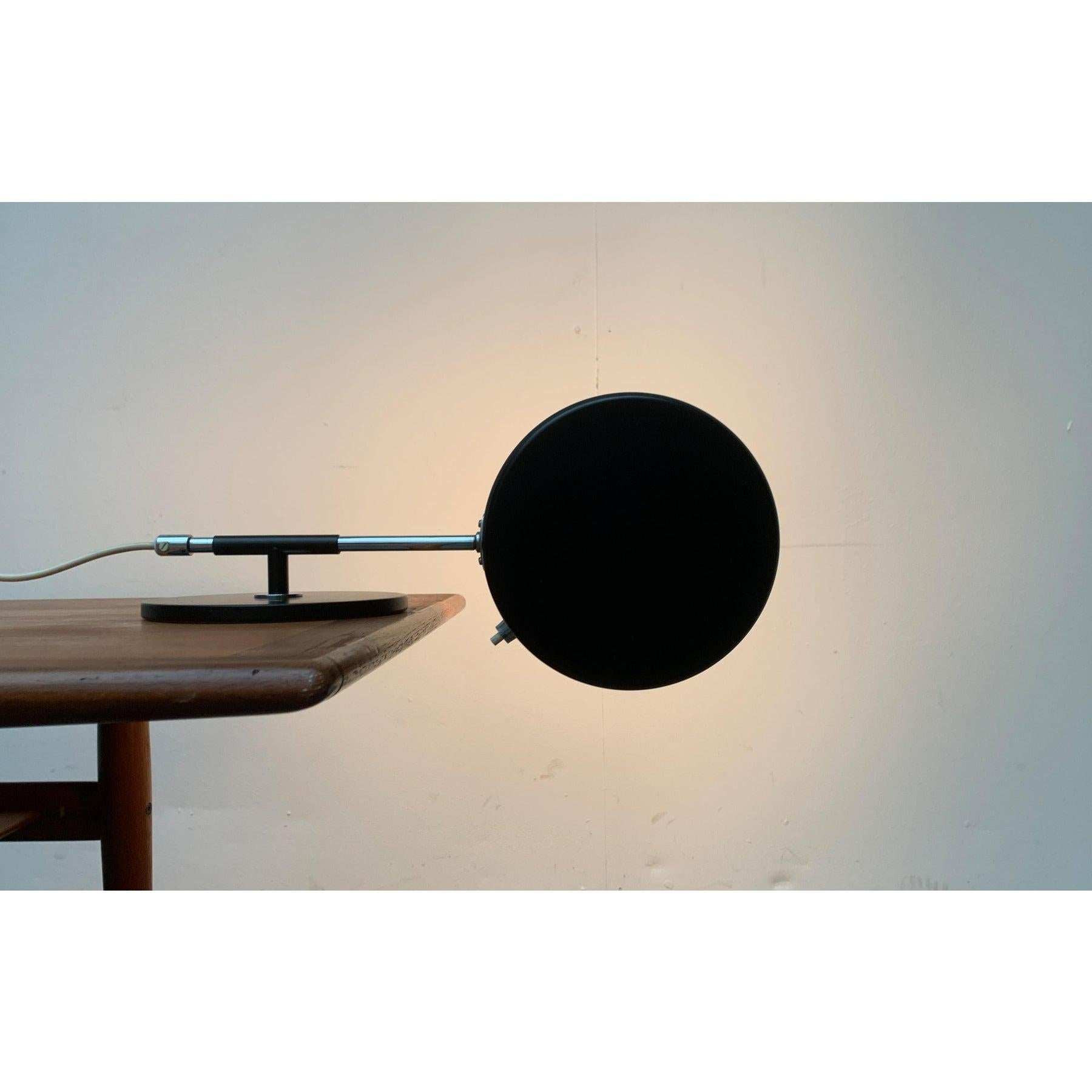 Rare shelf or table lamp from the Swedish manufacturer Atelje Lyktan after a design by Anders Pehrson from the 60s.

A minimalist design. Particularly eye-catching is the simple shape of the shade as a flat cylinder. The opening is covered with a