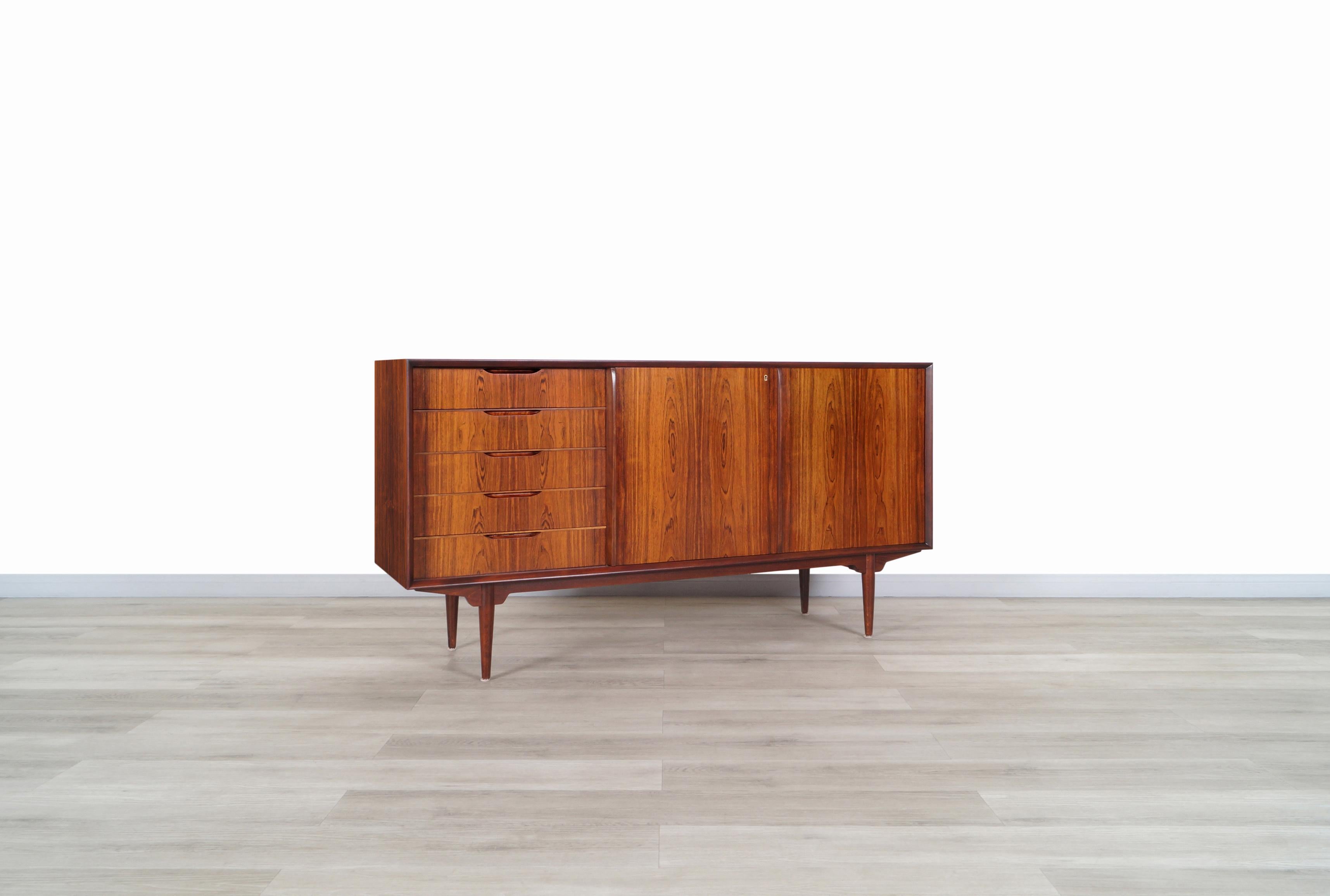 Wonderful mid-century rosewood sideboard designed Svante Skogh and produced by Seffle Mobelfabrik in Sweden, circa 1960s. Features an elegant design where the beautiful Brazilian rosewood grain that surrounds the entire case stands out. On the front