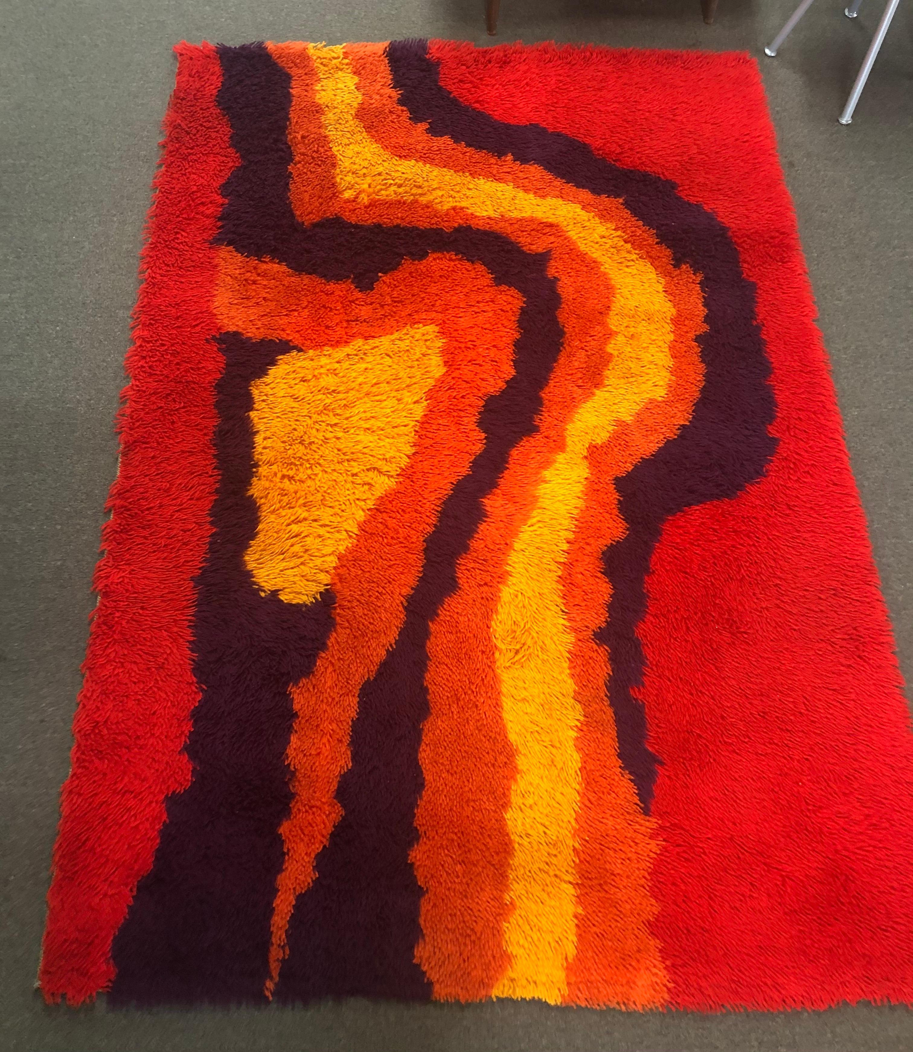 A very cool midcentury shag Rya rug from Sweden, circa 1970s. The wool rug is in very good vintage condition and has bright, vibrant colors (red, orange, yellow, purple and brown). It measures 54