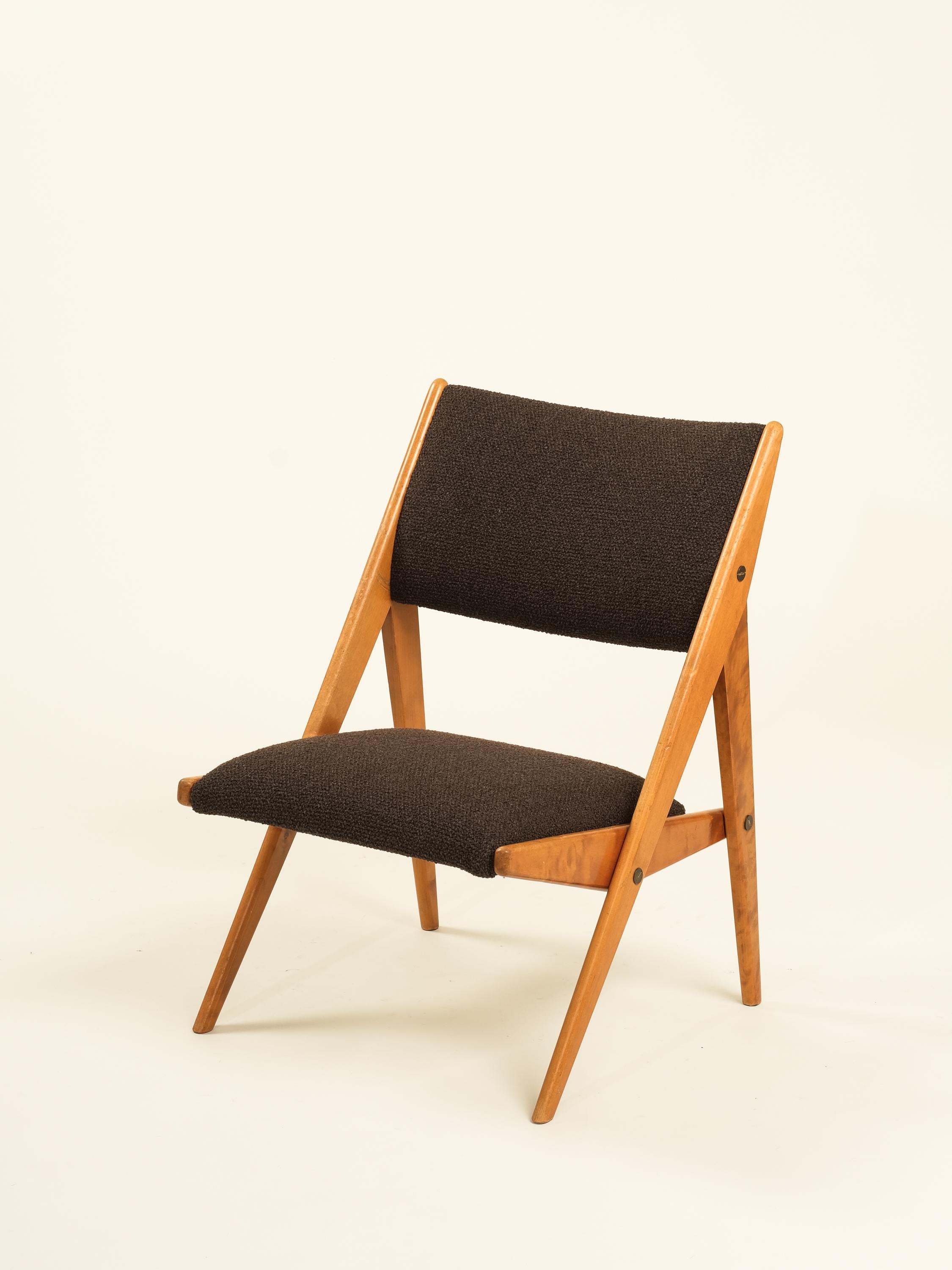 Una poltrona svedese degli anni '50 realizzata in faggio massiccio con un caratteristico profilo a forma di capriolo. Rivestito in un tessuto marrone con una trama a nodi in stile boucle. Un modello pulito, comodo e compatto.
