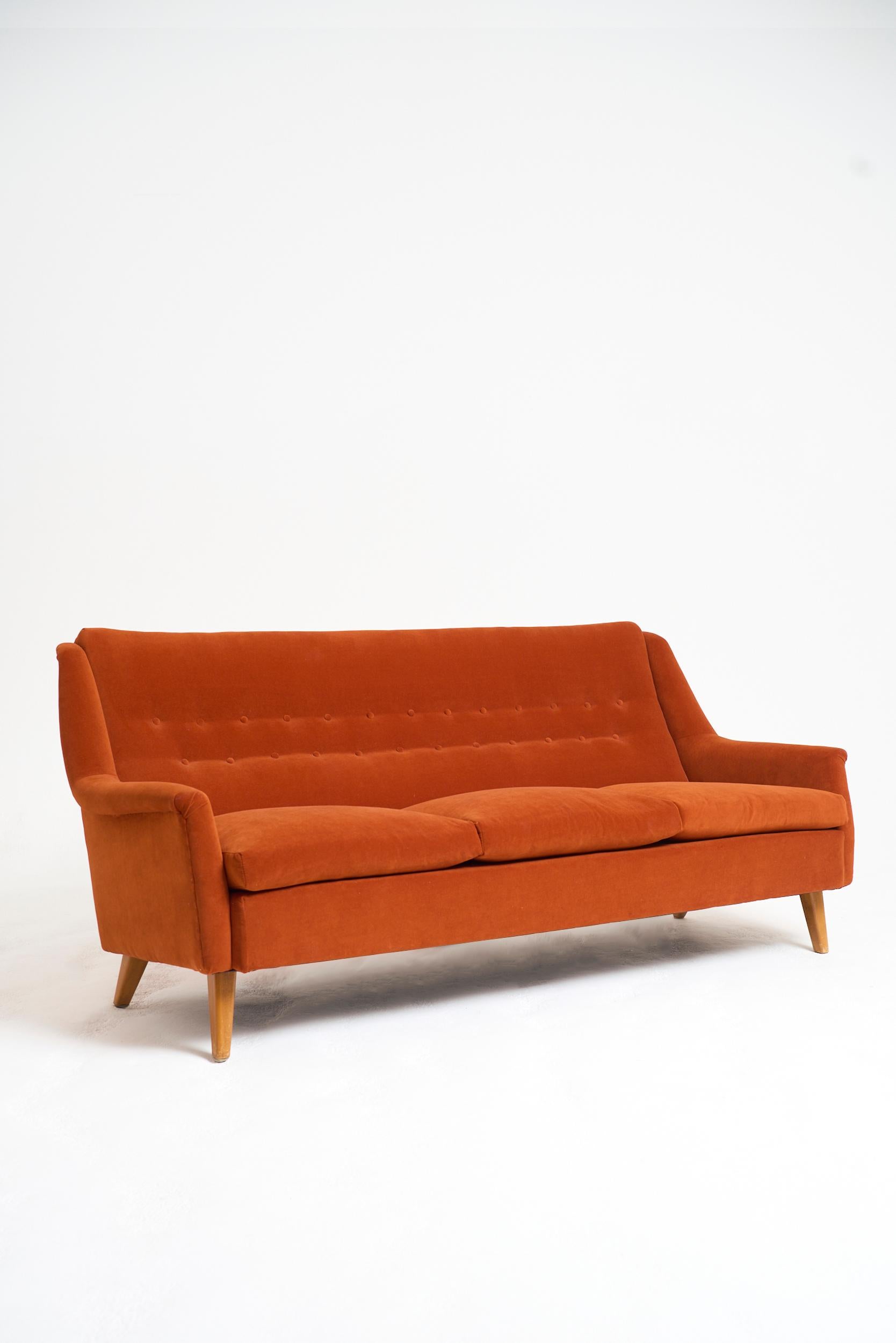 A buttoned sofa, upholstered in burnt orange velvet
Sweden, Circa 1940-50
