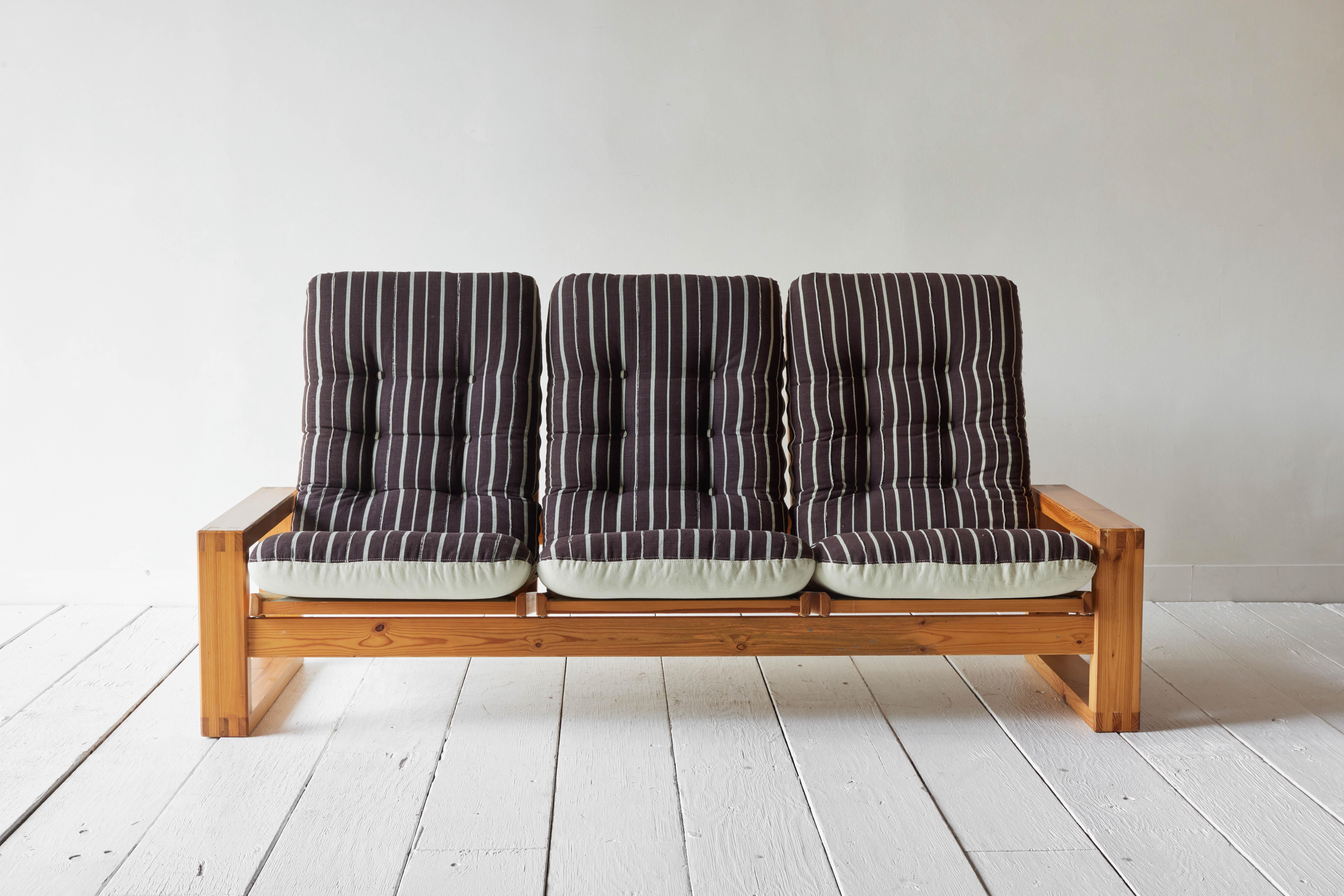 A mid-century Swedish pine sofa reimagined with vintage Asoke textiles. 
  