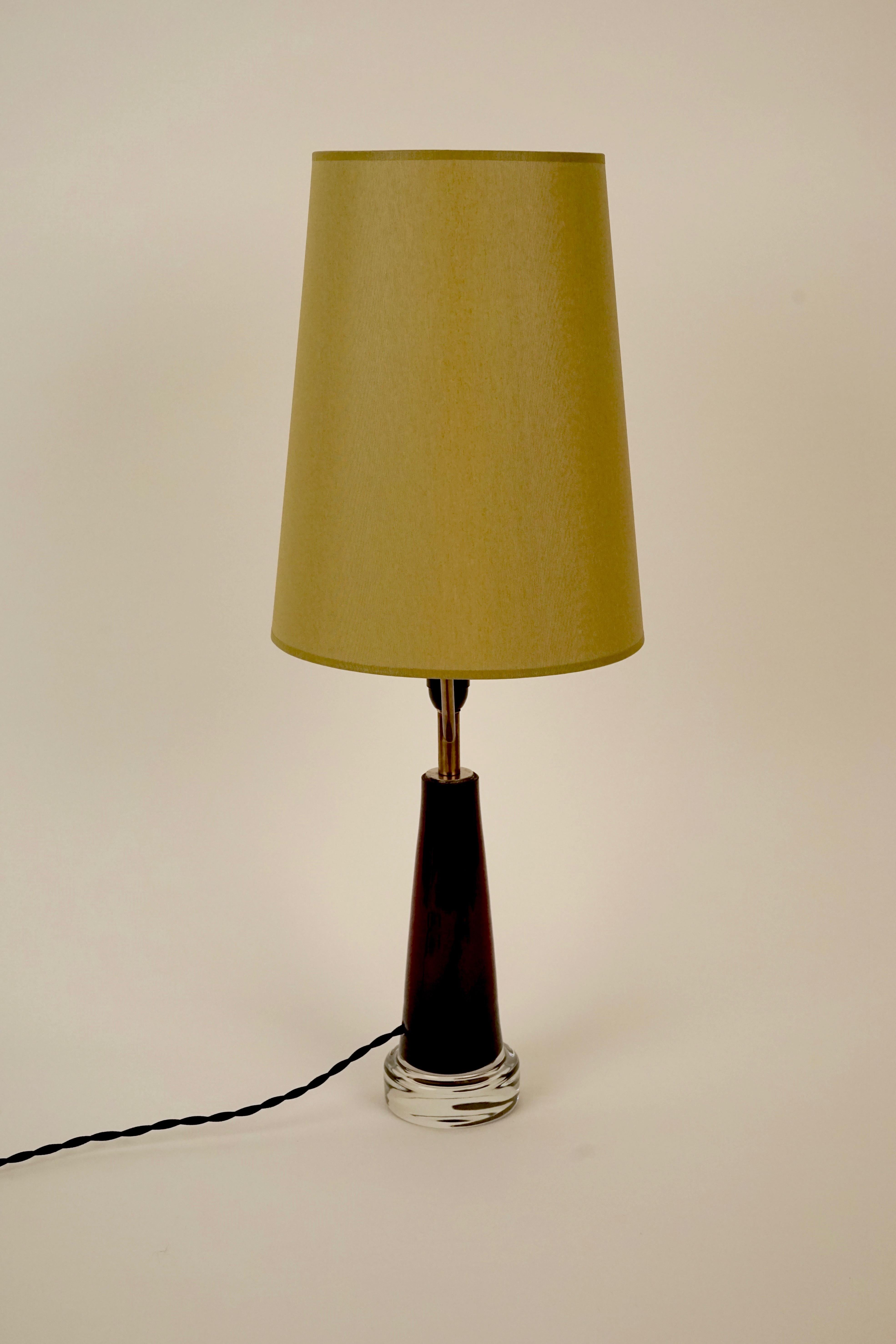 The glass base of the lamp is hand crafted in deep Bordeaux color. 
The shade is new, made in green silk.
The textile cable runs through the glass base and adds a nice detail.
The shade support is made in brass.