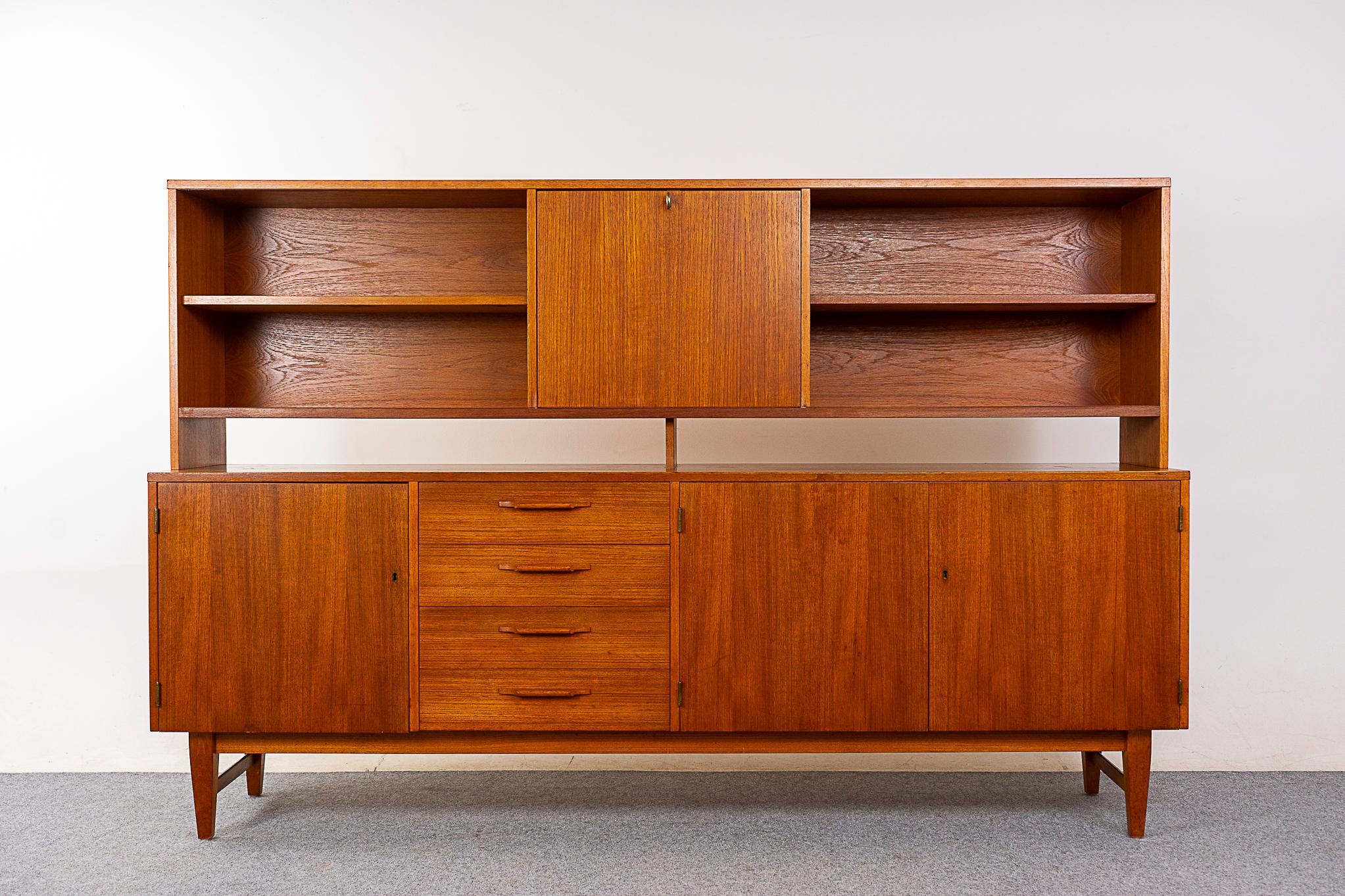 Teak sideboard & hutch, circa 1960's. Mirrored bar and open cubbies up top, glass sliding door can be added. Locking doors, removable shelving and felt lined drawers.  Top and bottom can be used independently. AB AJFA Mobelfabrik maker's mark