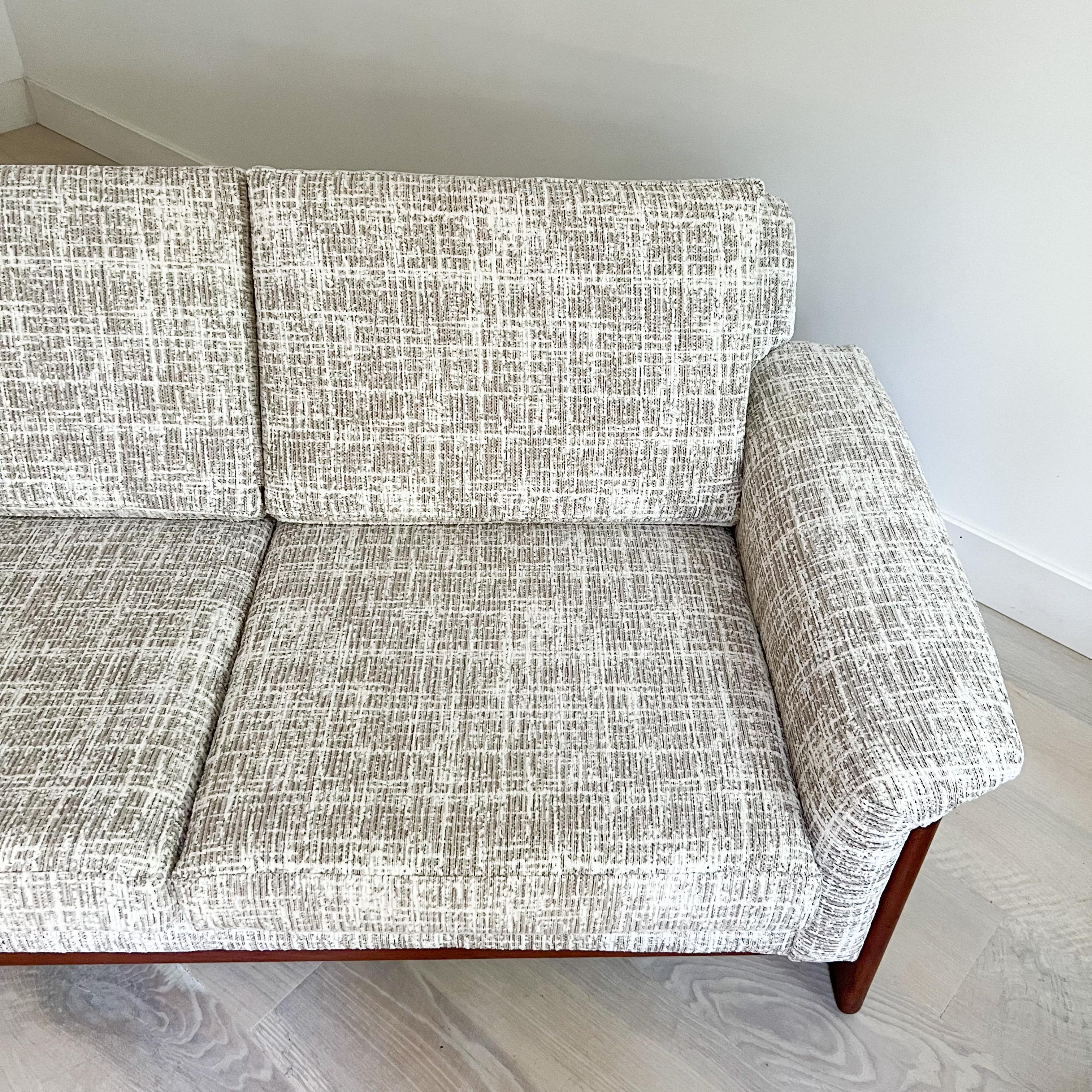Mid-Century Modern Swedish sofa with teak frame designed by Folke Ohlsson for DUX. New foam and soft white/beige textured upholstery. Some light scuffing/scratching to the teak frame from age appropriate wear.