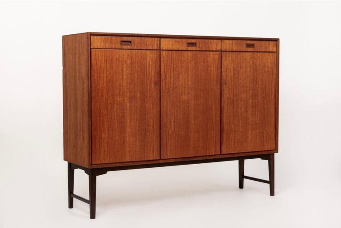This vintage mid century modern tall sideboard cabinet or cabinet credenza was made by Skaraborgs in Sweden circa 1960. This high credenza or server features classic Scandinavian modern styling with a minimalist design and clean, geometric lines.