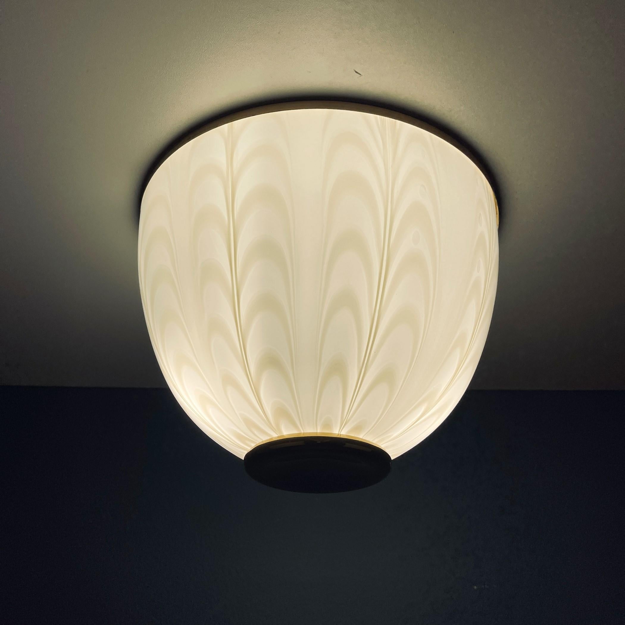 The unusual swirl Murano glass ceiling or wall lamp was made in Italy in the 1970s. Can be used as a ceiling or table lamp. The electrical system is fully functional and includes the 2 original E27 bulb holder. Suitable for 220 and 110 voltages.