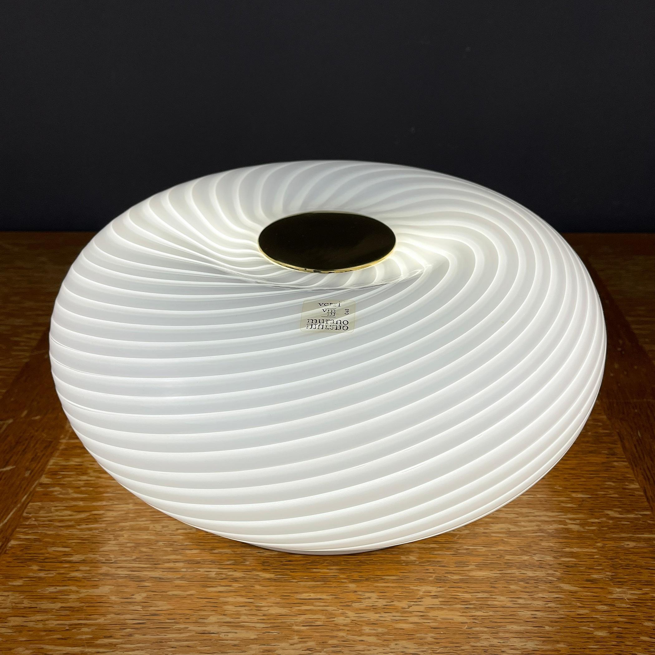 The unusual large swirl Murano glass lamp Vetri Murano 048 by Leucos was made in Italy in the 1970s. Can be used as a ceiling, table or wall lamp. Founded in 1962 in Scorzè in the outskirts of Venice, and later moved on to the neighborhood of
