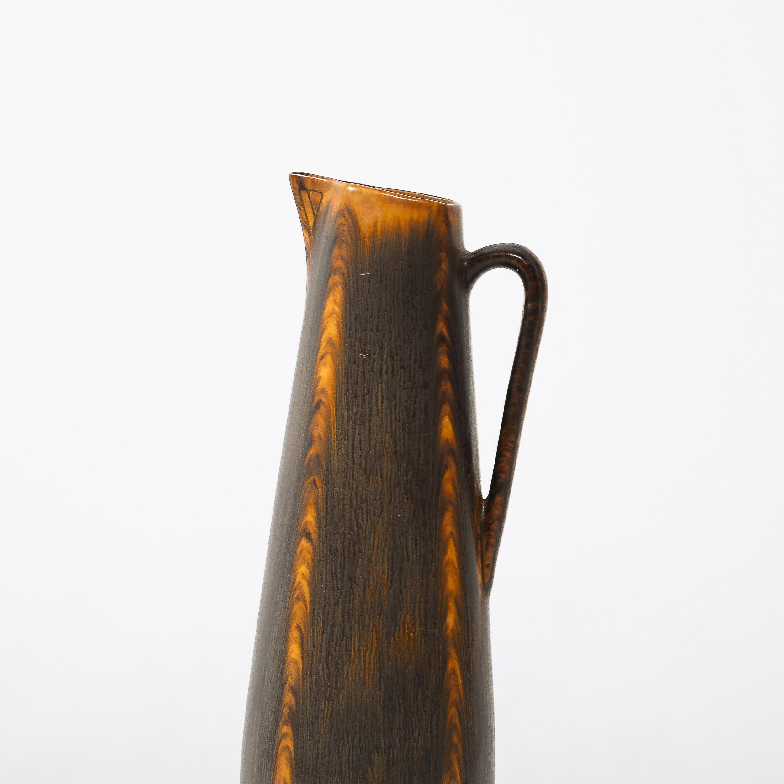This beautifully formed Mid-Century Modernist Swirled Orange and Charcoal Glazed Vase by Gunnar Nylund for Rörstrand originates from Sweden, Circa 1950. Has an elegant profile with a rounded rectangular body, upwardly sloping mouth and cubist