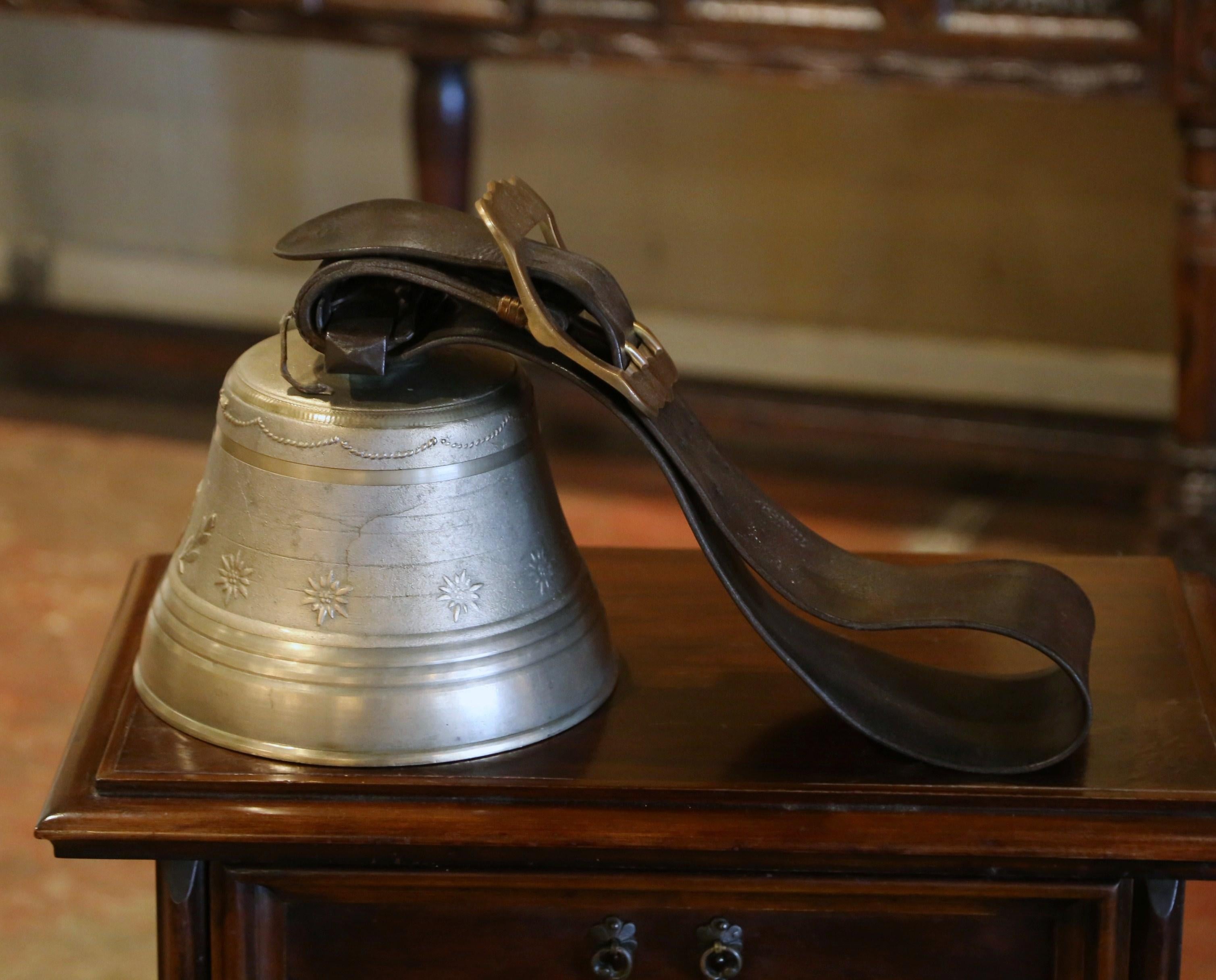 Bring the Swiss countryside into your home with this large antique bell and collar. Crafted in Switzerland, the elegant bronze bell features several motifs in relief including swag motifs around the top, floral and laurel leaf decor in the center