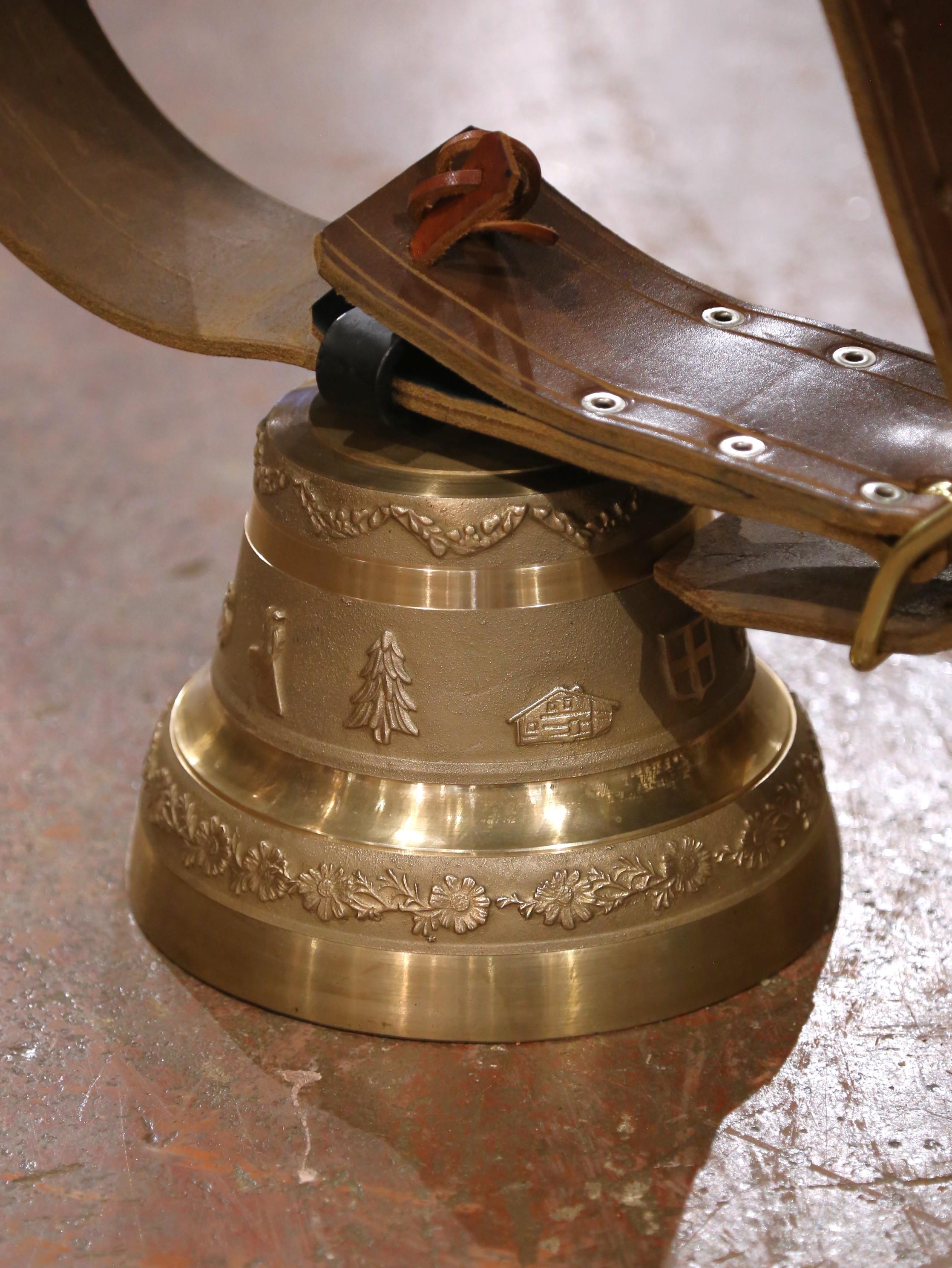 Bring the spirit of the Swiss Alps into your home with this impressive large-scale bronze cowbell, crafted in Switzerland circa 1960. Cast in solid bronze, the bell features beautifully embossed alpine motifs in relief, including a Swiss chalet, fir