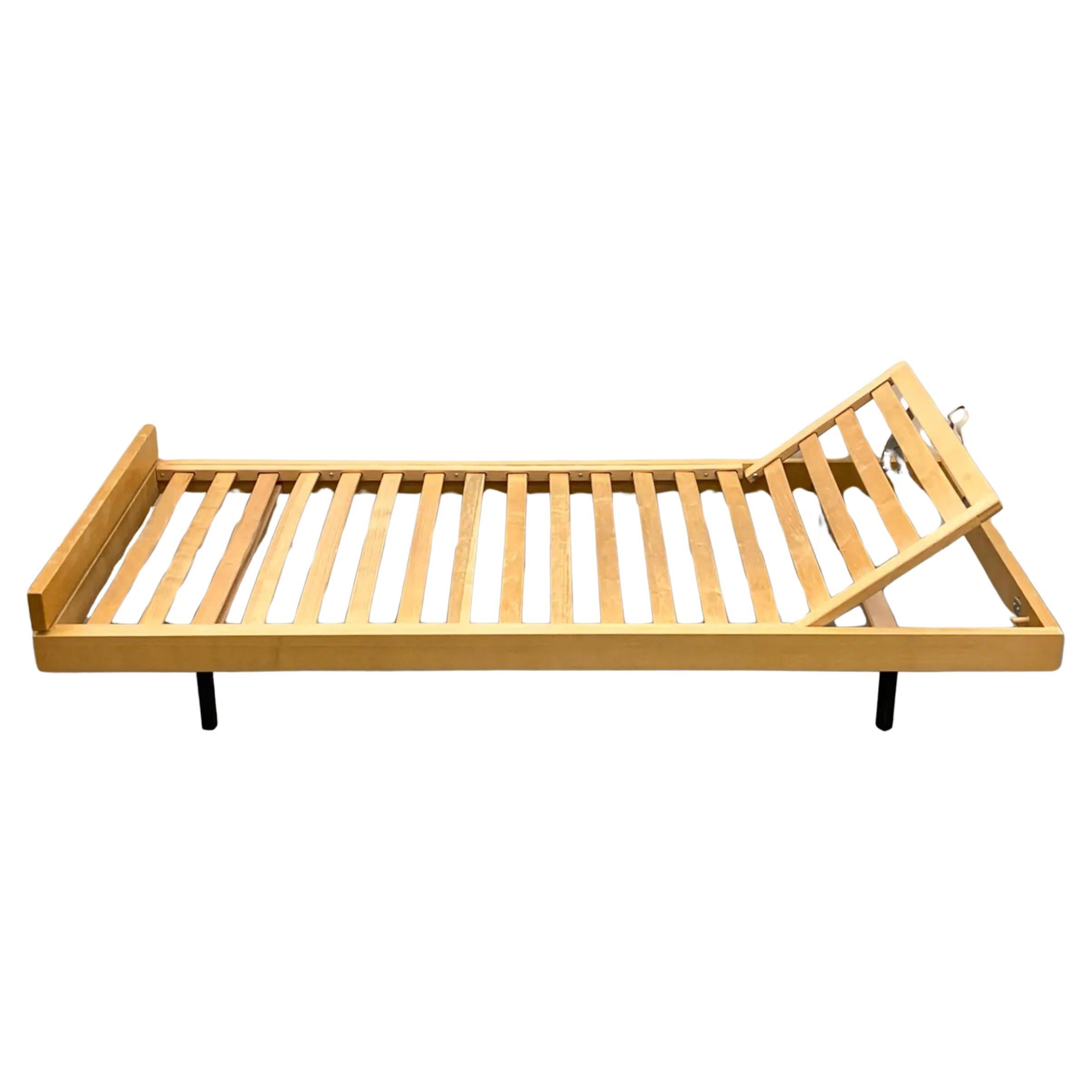 Midcentury Swiss Modern chaise daybed by Holma with ash and rosewood wood frame and legs. Has articulating headrest with collapsible legs and hidden casters, allowing for convenient roll-under-the-bed storage, c. 1970. Good vintage condition does