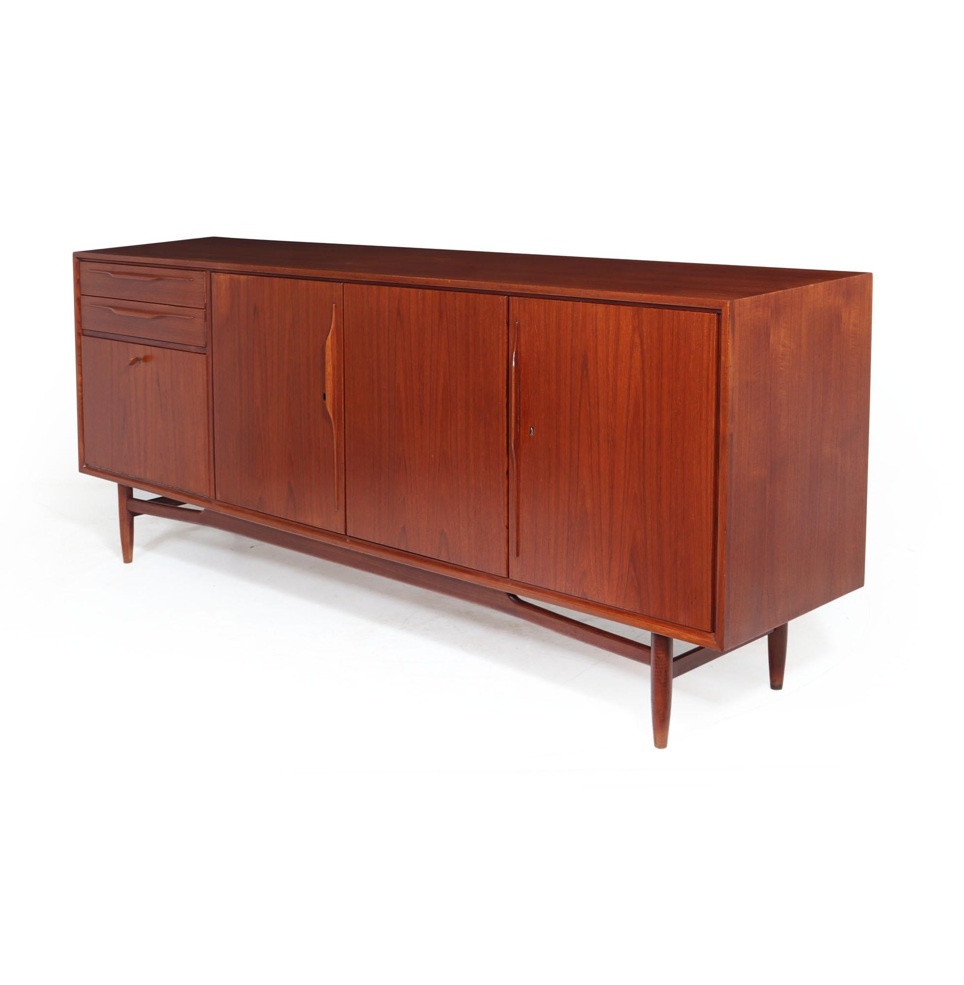 SWISS TEAK SIDEBOARD
A Swissteak made Teak sideboard produced in the 1960s, manufactured in the Danish style with Swiss quality Manufacturing, the sideboard has 3 drawers with fold down dry bar section below, to the right are a further three