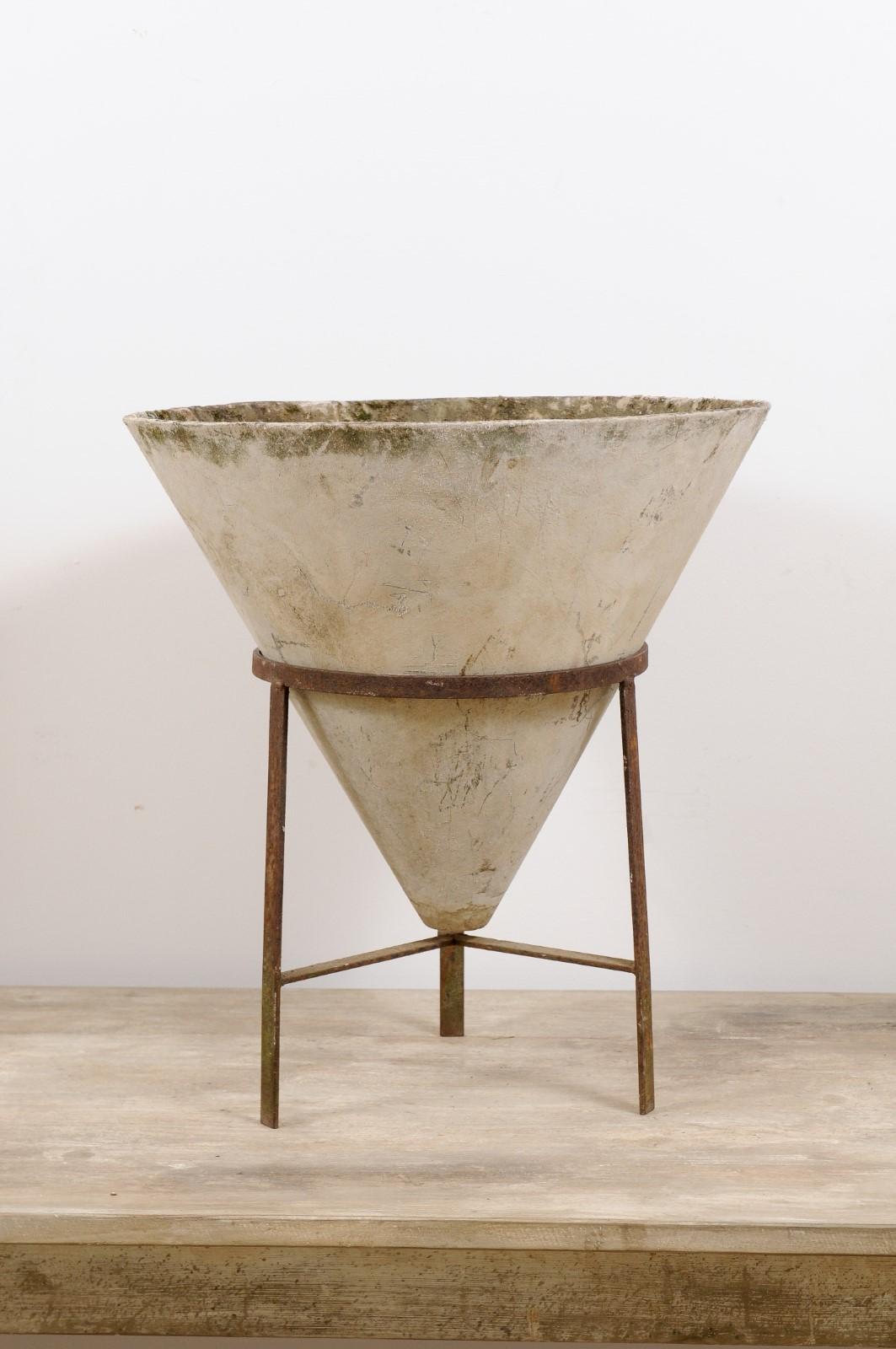 A vintage Mid-Century Modern Willy Guhl cone-shaped outdoors or indoors concrete planter with iron stand from Switzerland, circa 1960. 

Why we love it: Concrete has never looked so chic! The conical shape and iron metal stand make this Willy Guhl