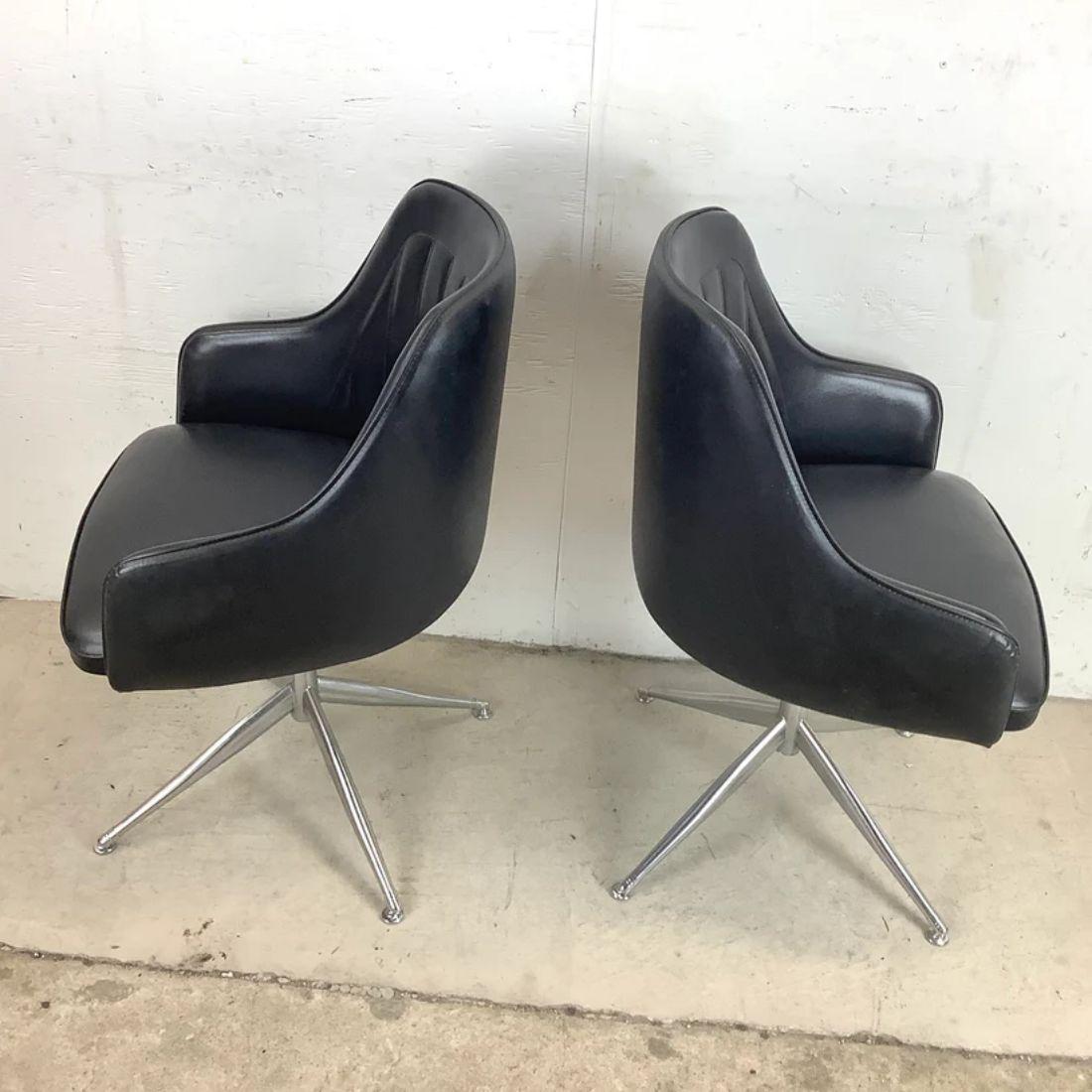 This stylish pair of midcentury swivel chairs feature unique Viko Baumritter style atomic design. The rounded seat backs fit the back comfortable while the striking four point steel bases feature tapered legs adding to the retro style of the