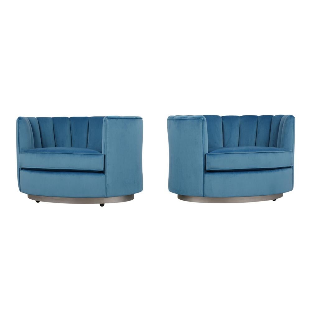 This pair of 1960s Mid-Century Modern style swivel chairs have been fully restored and are newly upholstered in a sky blue velvet color fabric with comfortable foam inserts. The club chairs have curved back/armrests featuring a channel design and