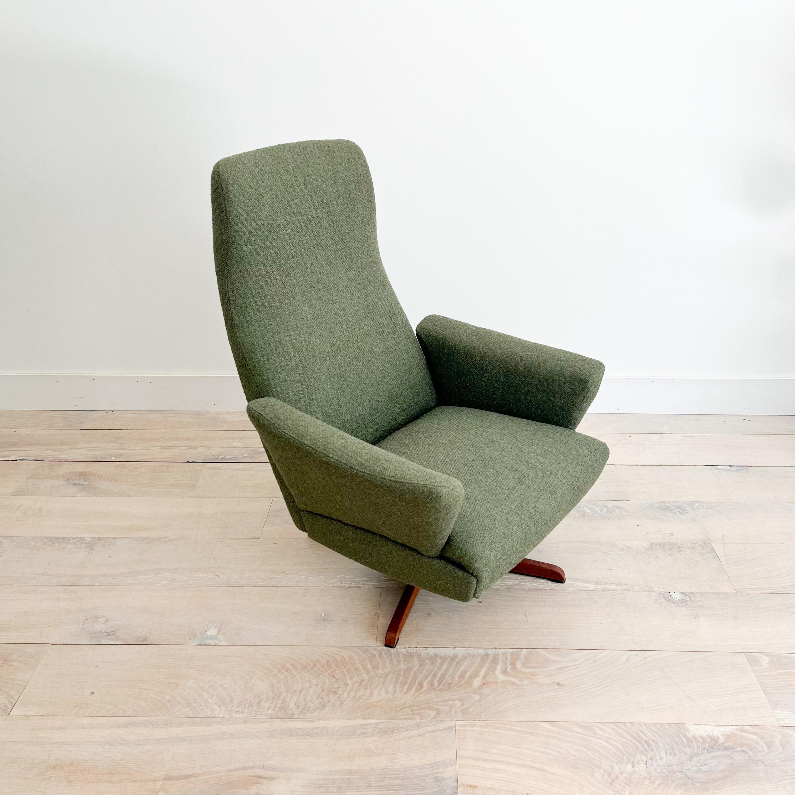 Mid-Century Modern high back swivel lounge chair by IB Madsen for Schubell. New olive green tweed upholstery. Some light scuffing/scratching to the base.