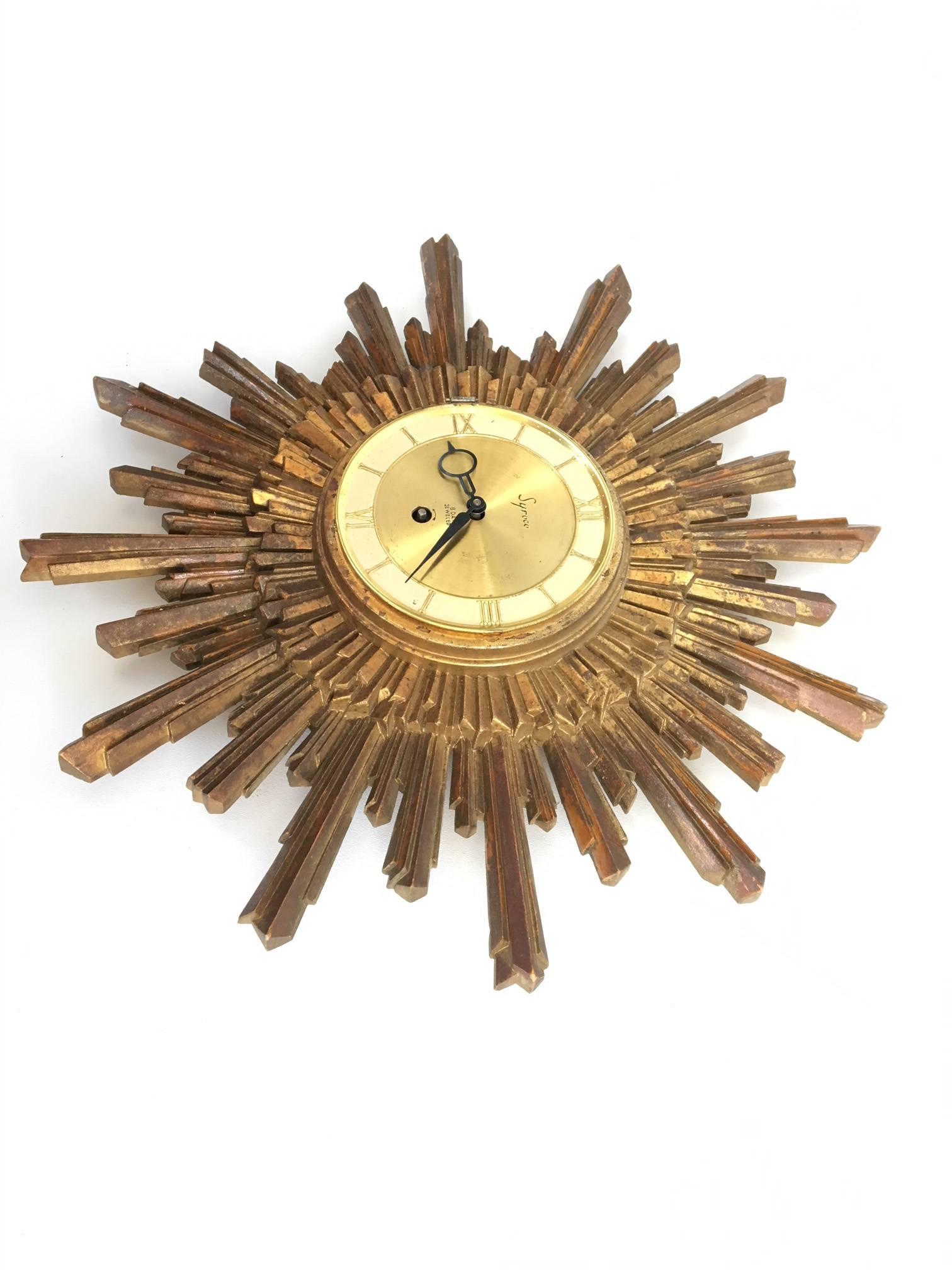 Syroco sunburst wall clock by the Syracuse Ornamental Company, circa early 1960s, before the company was purchased by Rexall. Made from 