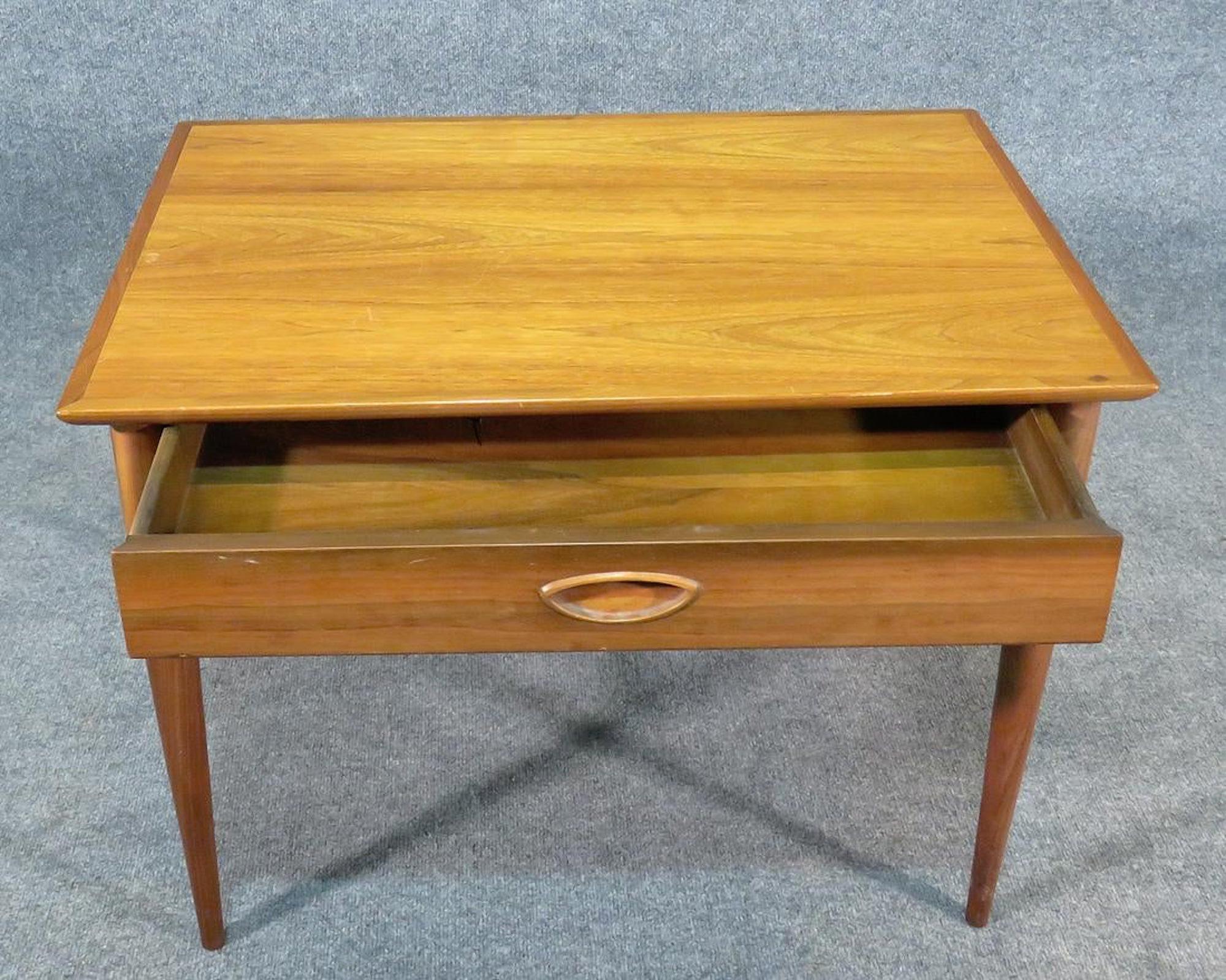 Vintage modern side table in walnut by Heritage with drawer.
(Please confirm item location - NY or NJ - with dealer).
  