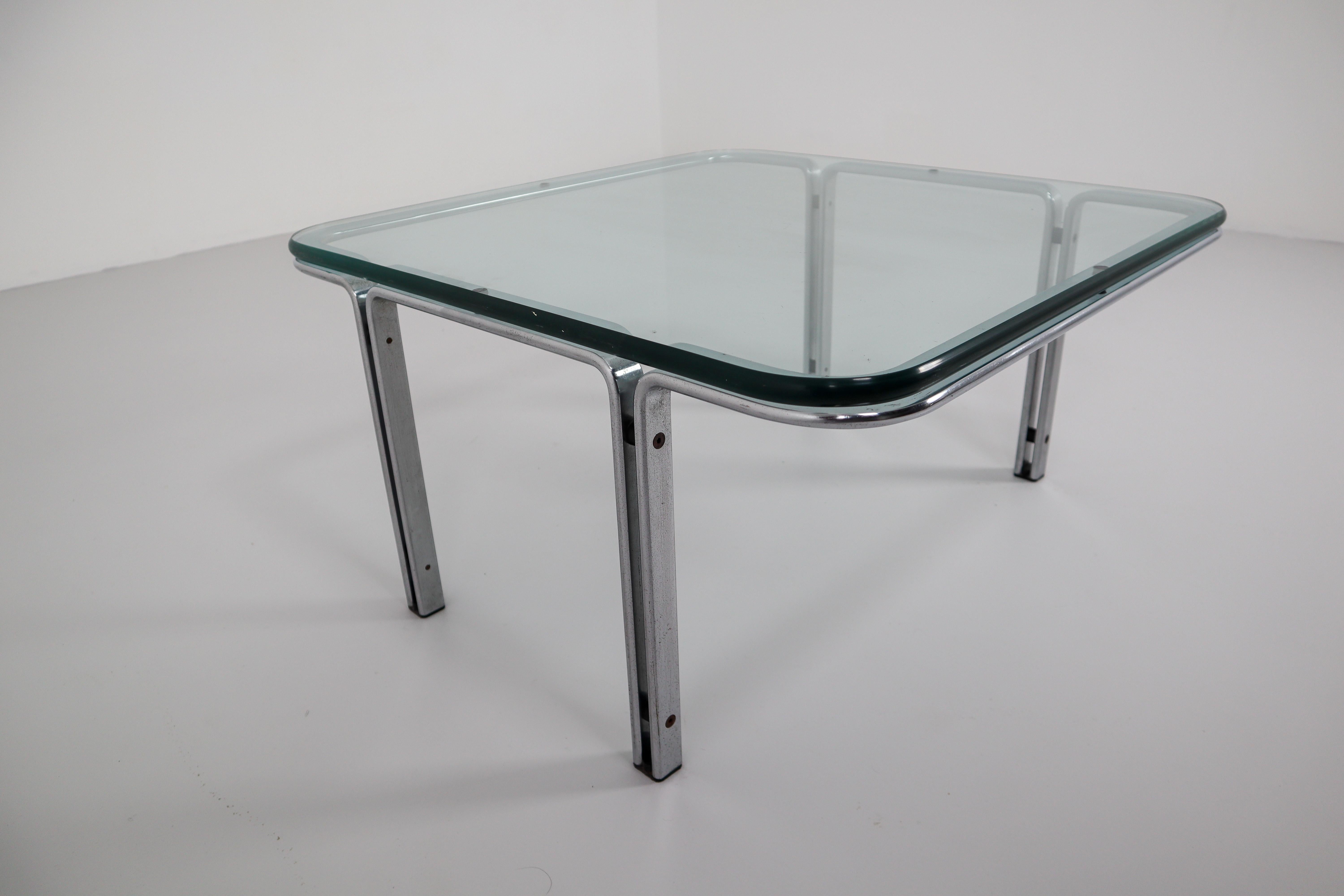 Mid-Century Modern coffee table designed by Horst Brüning for Kill International around 1970. The base, of soft-edged matte chrome steel, has spaced parallel uprights .A heavy piece of 20 mm crystal-plate glass sits on top.In Fine original