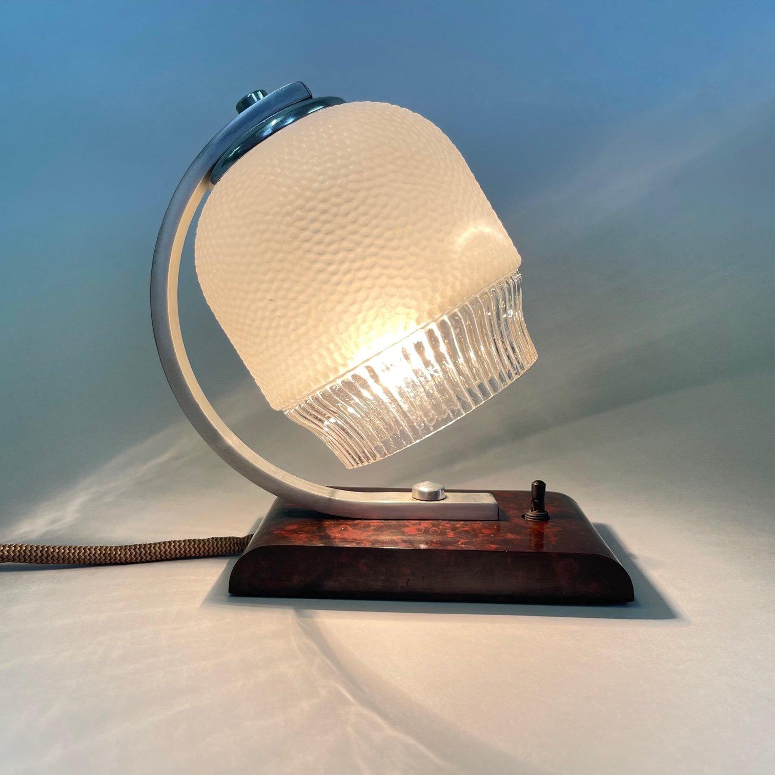 Very nice small vintage table lamp made of glass, metal and imitation veneer.
