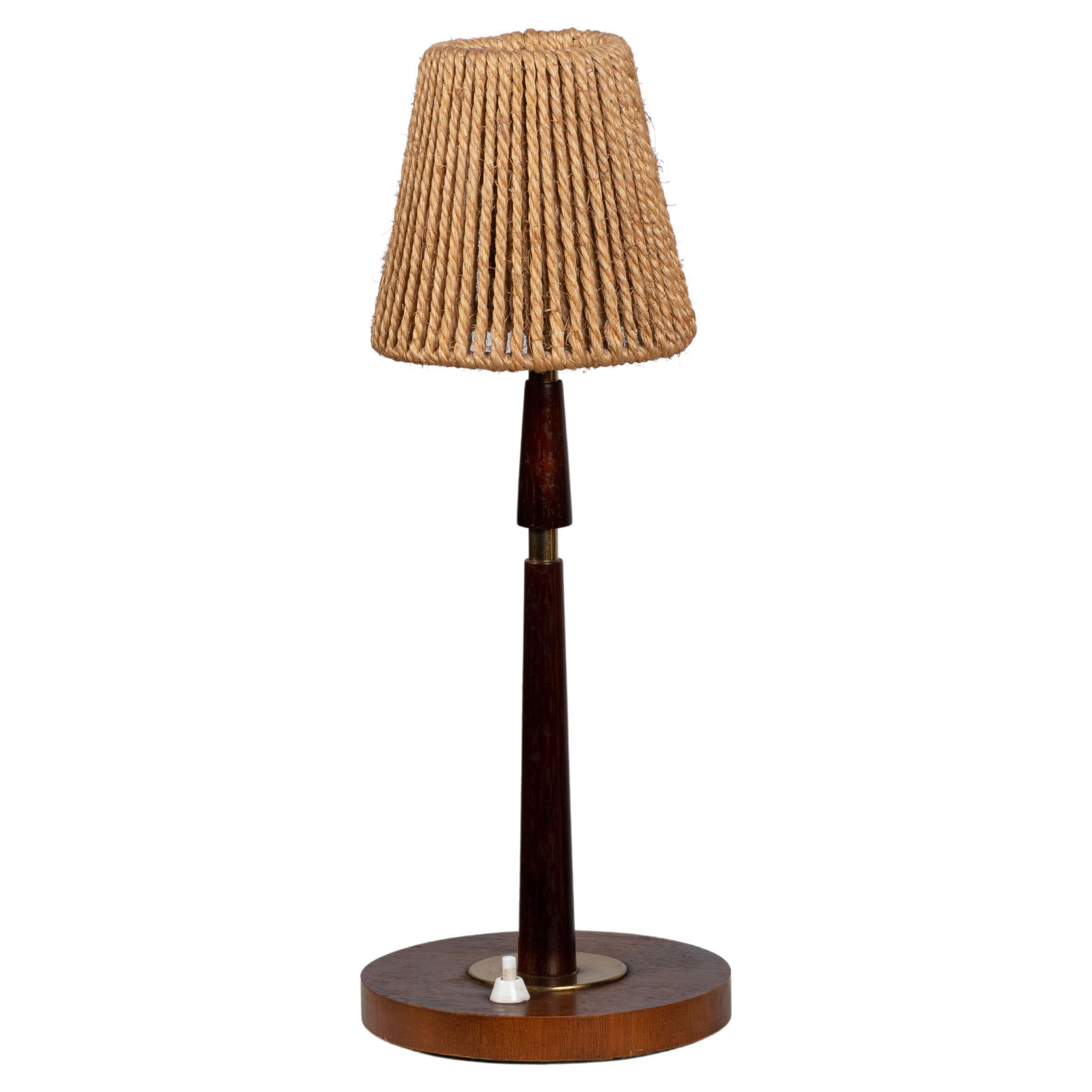 A Mid-century table lamp. In solid Teak, Denmark, 1960. 

Elegant teak lamps, pleated lampshade. It is in good general condition and works perfectly. The diffused light is very pleasant and the lamp offers a warm atmosphere.

Height without