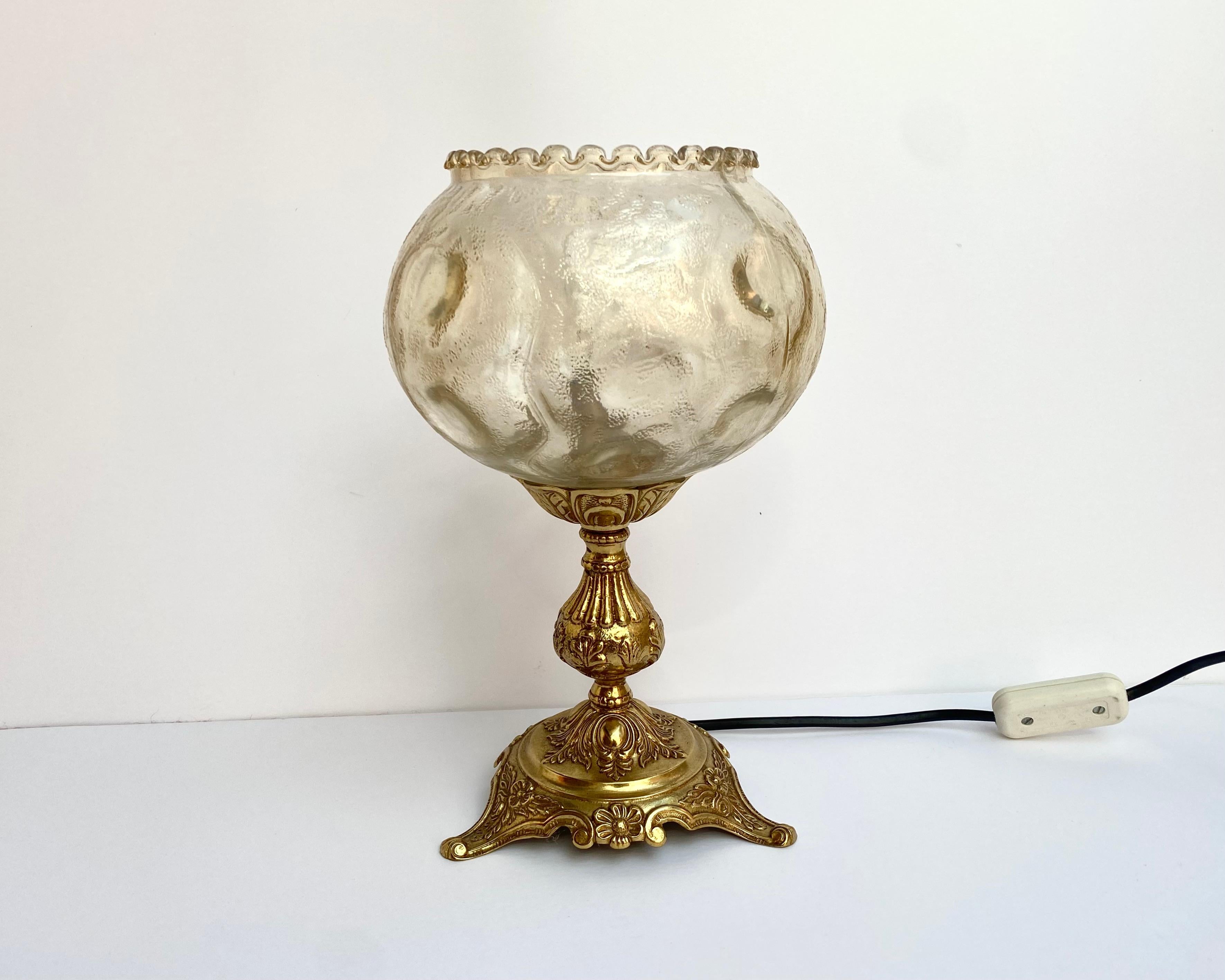 Very Beautiful mid-century lamp on a gold repulsed brass base finished by a shortbread glass from the Belgian manufacturer.

The lampshades are open balls with a subtle, beautiful pattern and a very light tint.

Glass and brass table lamp is a rich