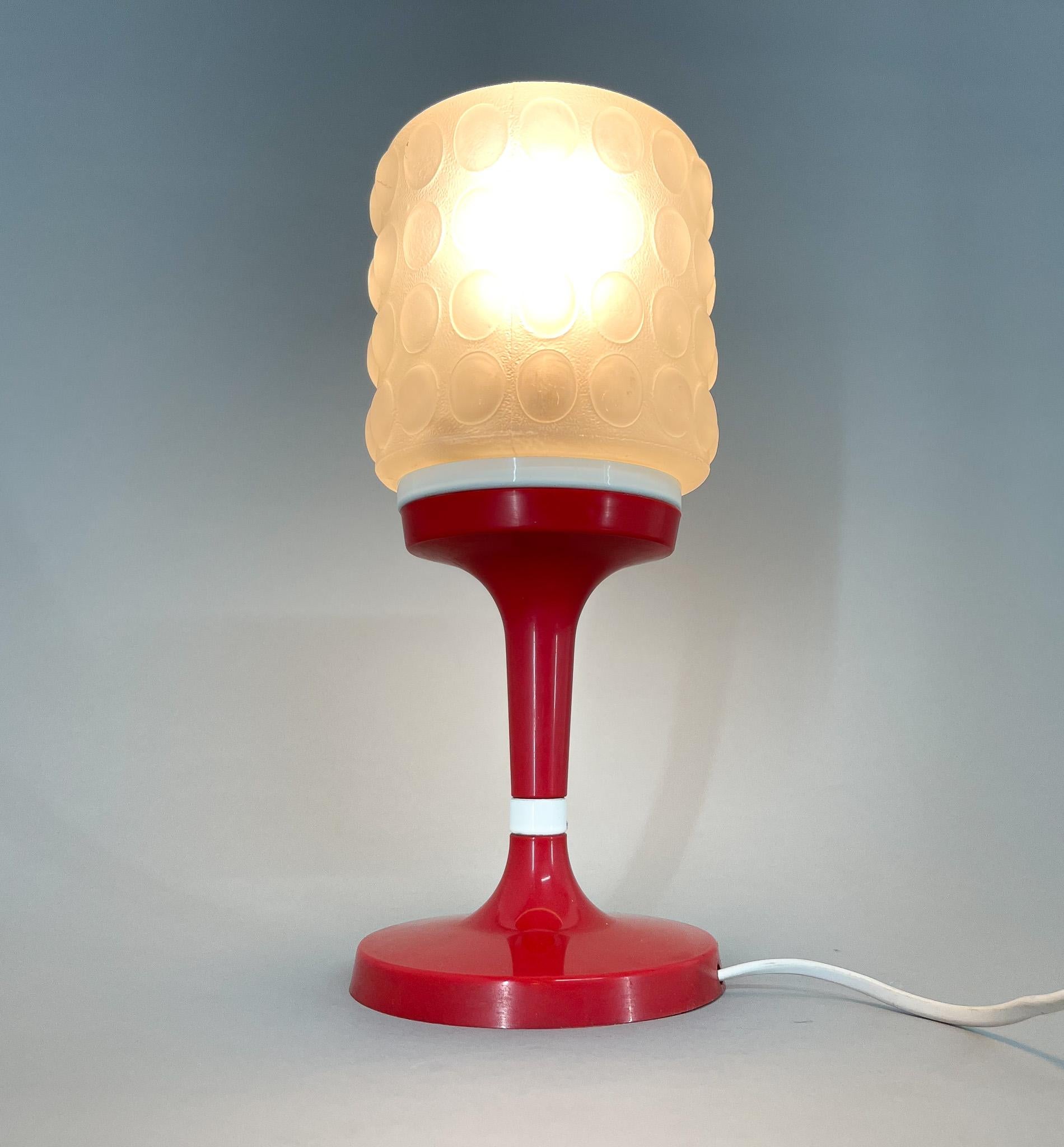 Vintage table lamp made of red and white plastic and glass. Produced by Elektroinstala Jílové in Former Czechoslovakia in the 1970s.